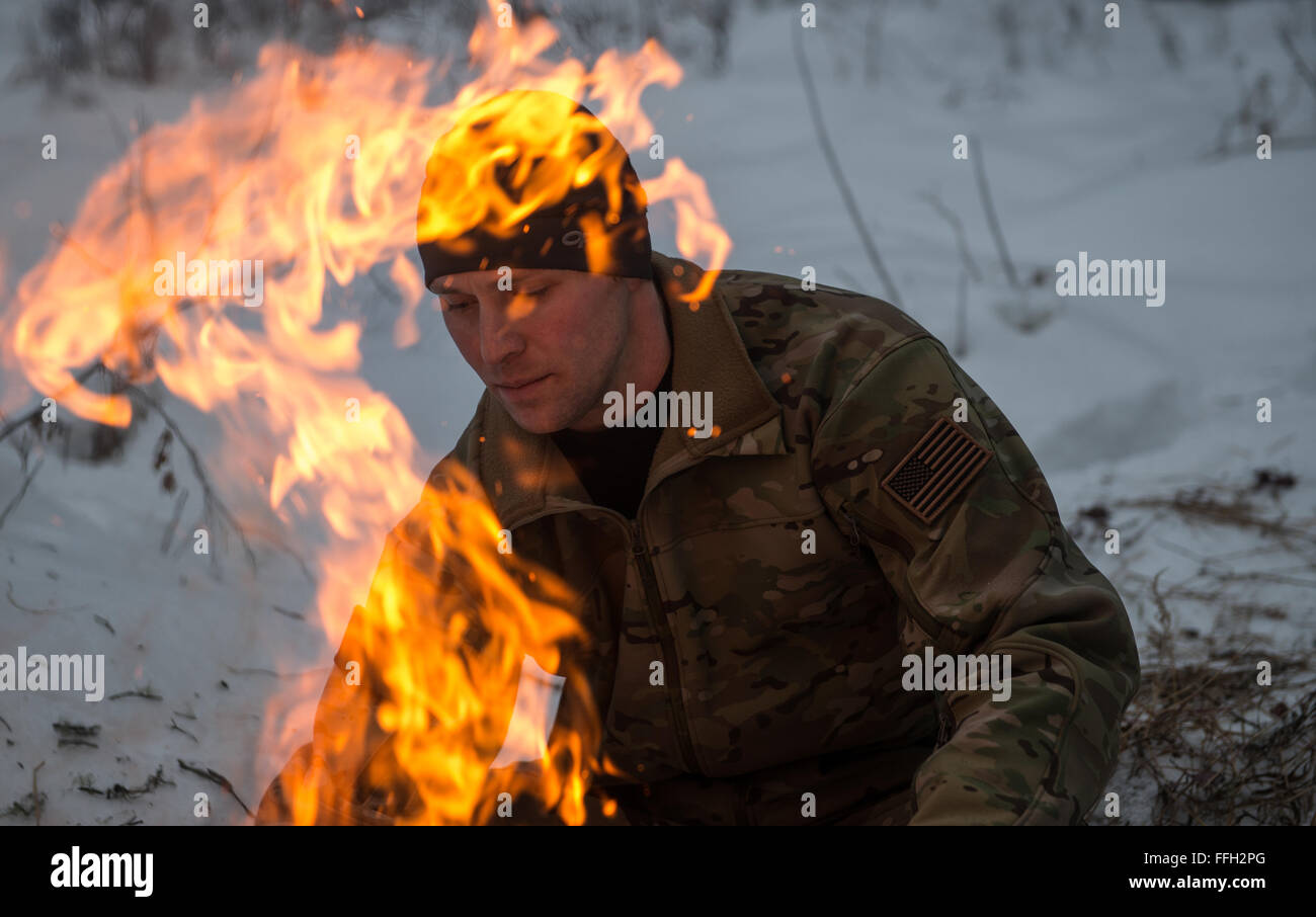 Staff Sgt. Seth Reab, Det 1, 66th Training Squadron, Arctic Survival School instructor, creates a small fire with a pile of tender branches during training. Fires can be used for signaling, heat and food during real-world survival situations.  To become a Survival, Evasion, Resistance and Escape specialist, one must know how to create a fire in many different types of weather conditions. Stock Photo