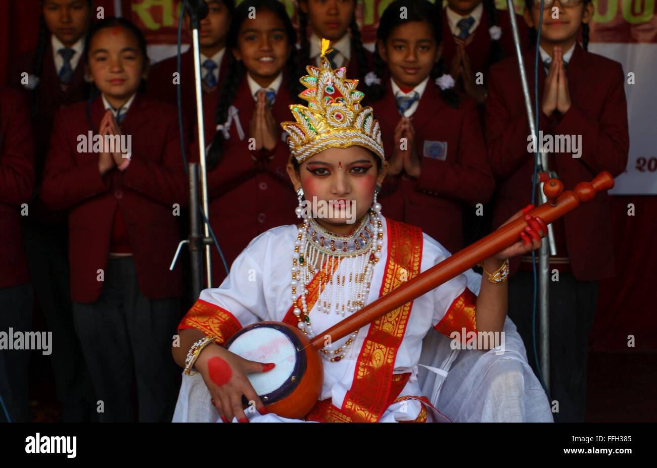 Kathmandu, Nepal. 13th Feb, 2016. A girl dressed up as Goddess Saraswati, goddess of Knowledge, participates in a celebration of Shree Panchami Festival at a school in Kathmandu, Nepal, Feb. 13, 2016. Nepalese Hindu Community celebrates this very day as the day of worshipping the Goddess of Knowledge, Saraswati. Students show their humble respect to Goddess Saraswati for knowledge and learning. This day also signifies as the beginning of spring season. Credit:  Sunil Sharma/Xinhua/Alamy Live News Stock Photo