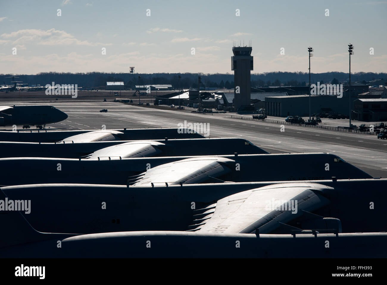 Several C-5 Galaxies sit on the flightline during the morning sunrise at Dover Air Force Base, Delaware, home to the 436th Airlift Wing. Stock Photo