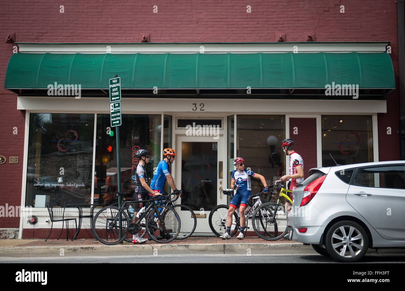 After reaching the halfway point of a conversational-pace bike ride Senior Airman David Flaten and his friends take a moment to relax, eat and drink at a local coffee shop in Staunton, Virginia. Flaten and his friends often meet up and ride to and from the coffee shop during a slower-paced training day. Stock Photo