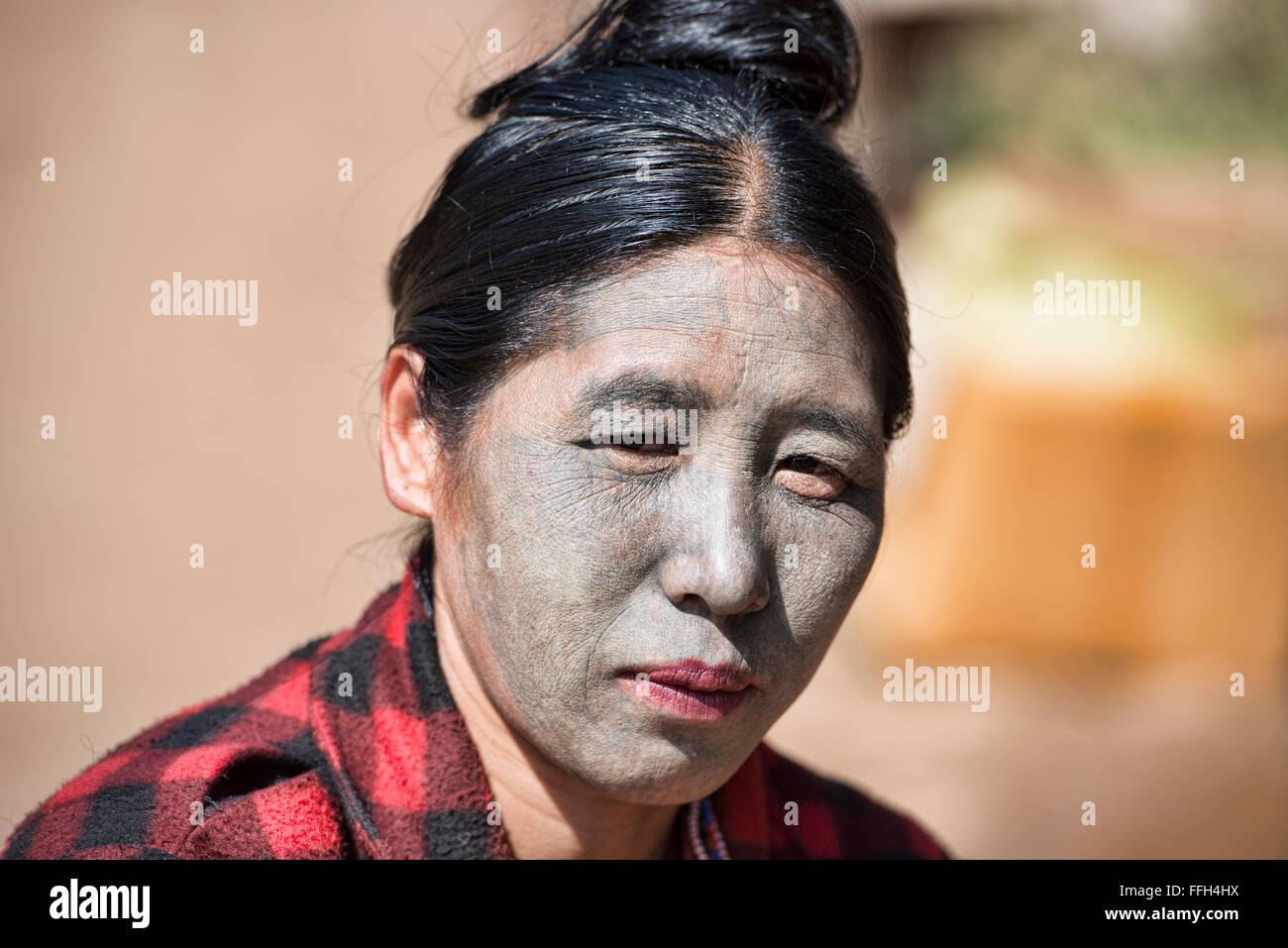 An U-Pu tribe Chin woman with full face tattoos, Kanpetlet, Myanmar. Stock Photo