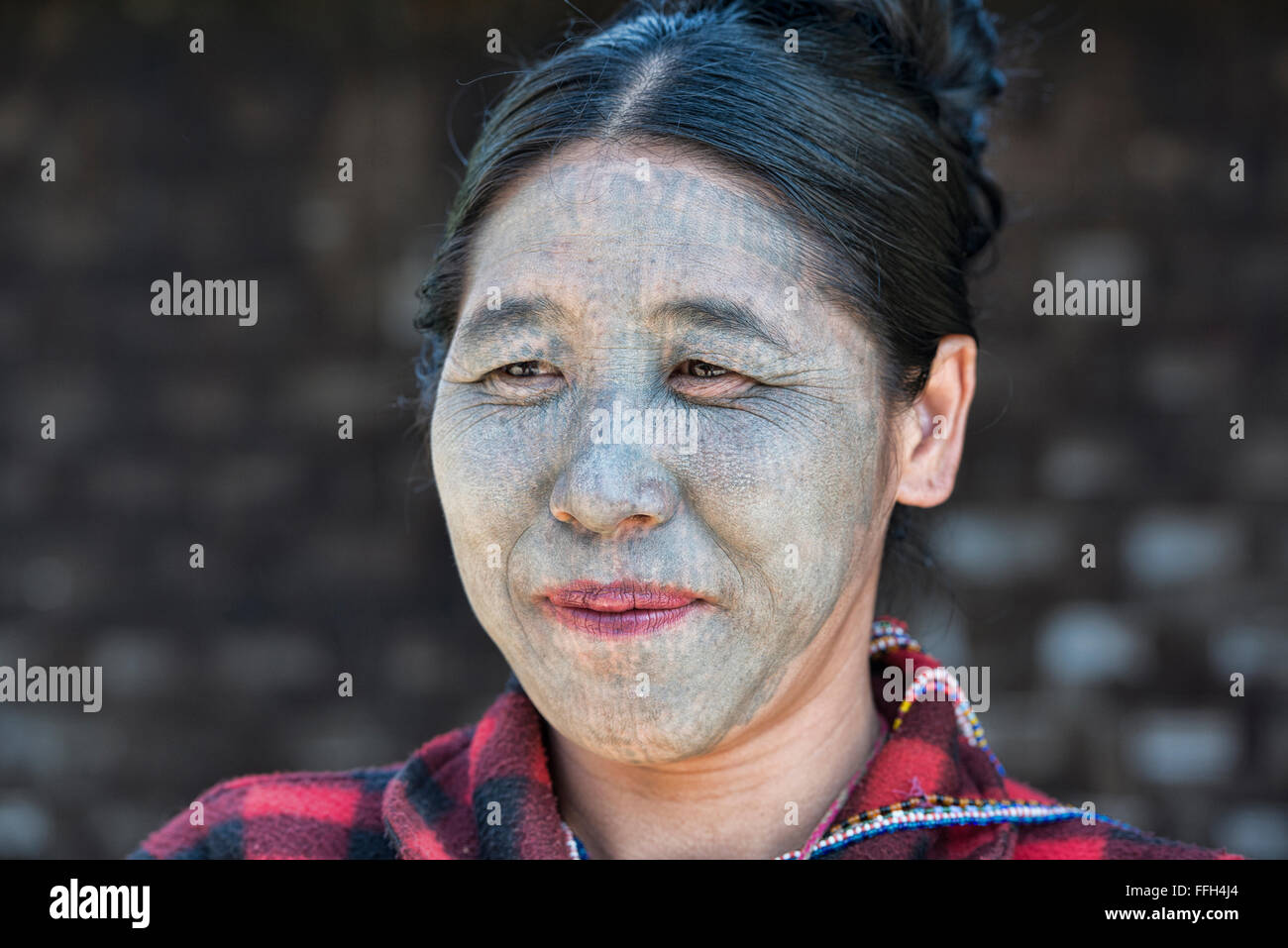 An U-Pu tribe Chin woman with full face tattoos, Kanpetlet, Myanmar. Stock Photo