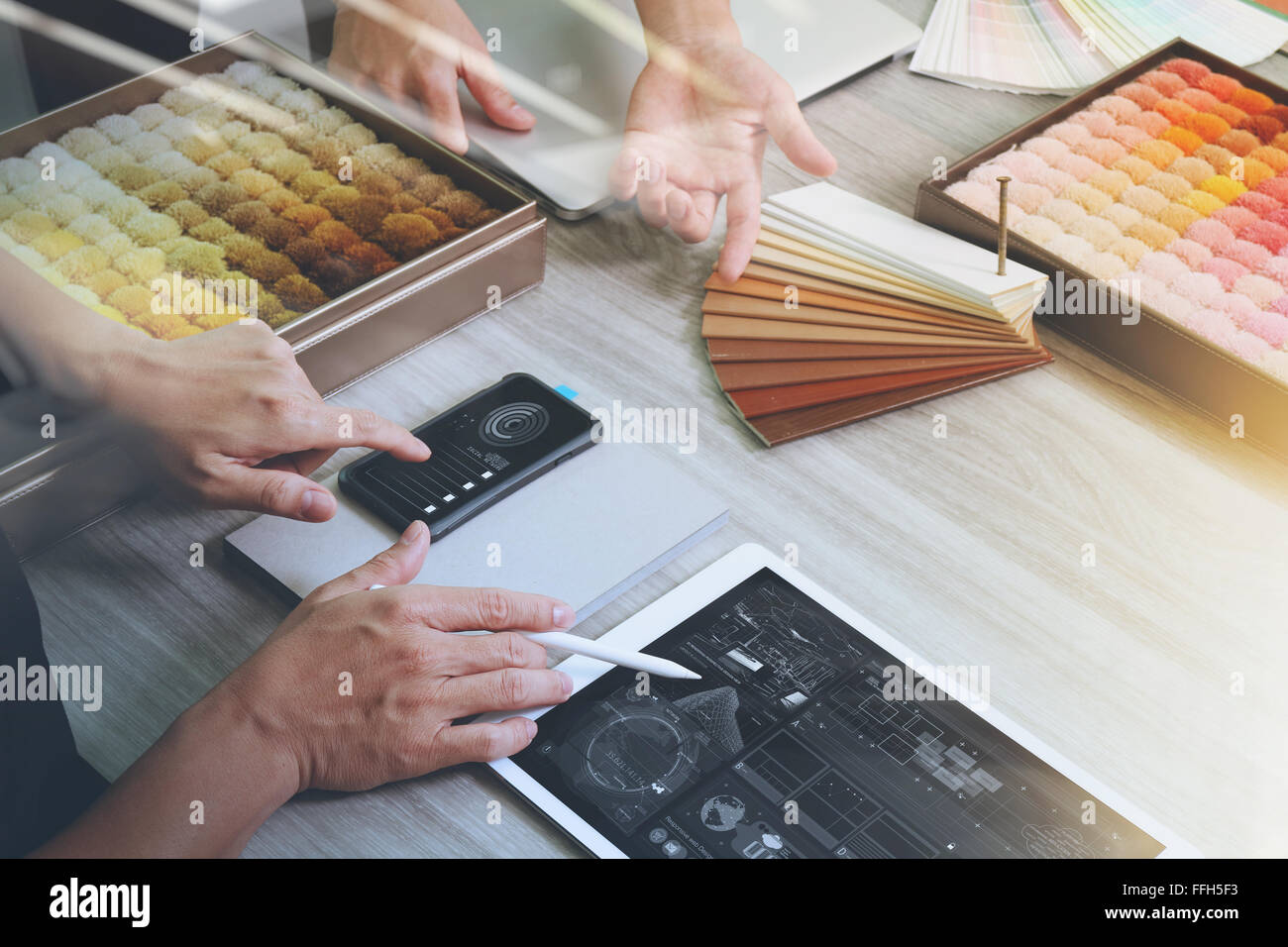 top view of two colleagues interior designers discussing data with ...