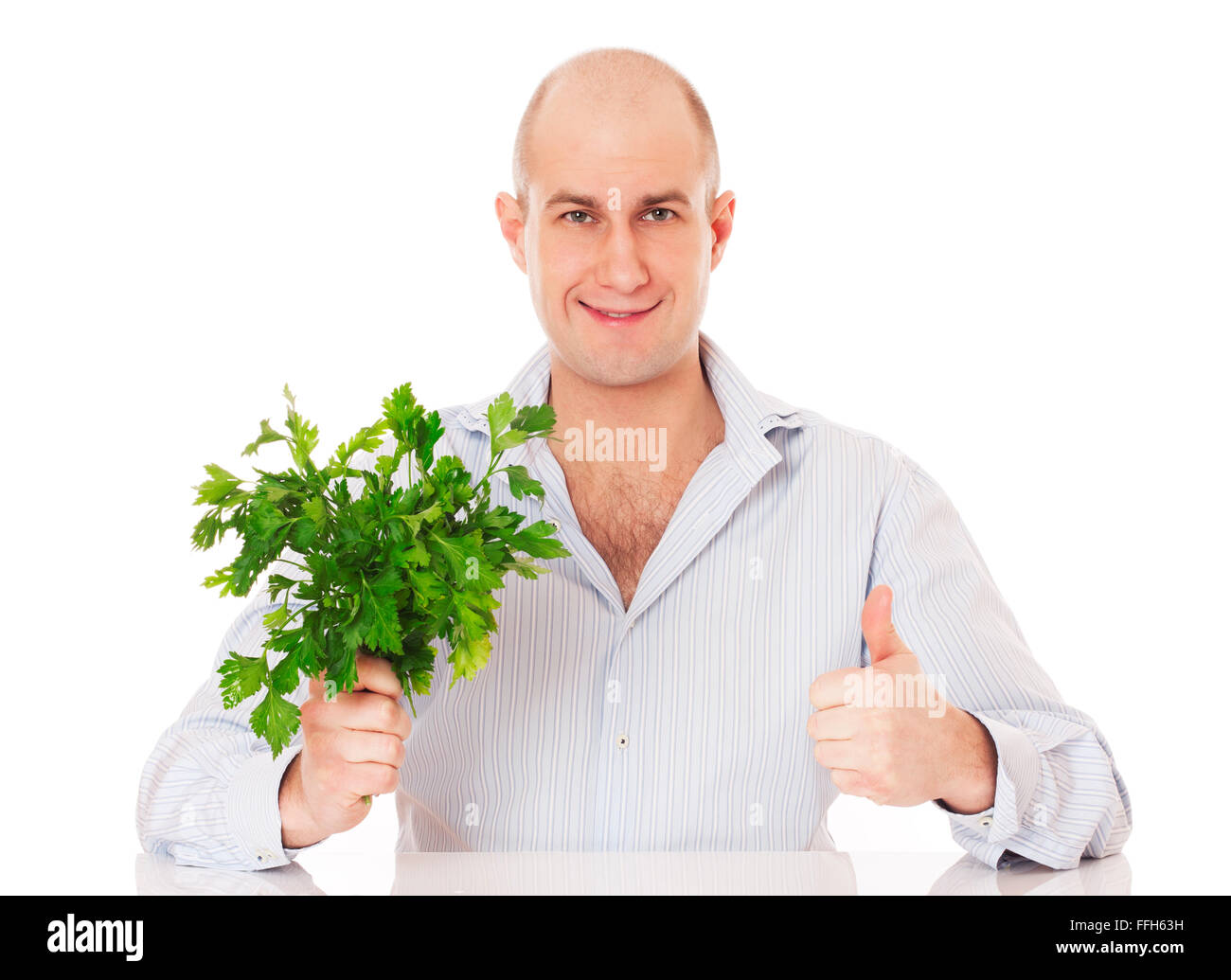 Man with bunch of fresh parsley in a hand. Isolated on white. Stock Photo