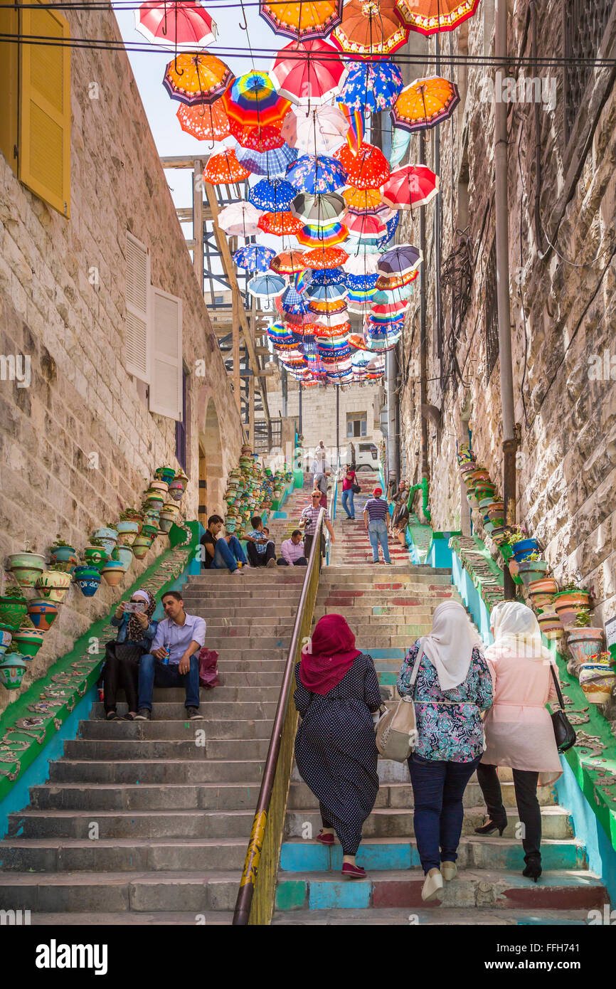 Stairs in old Amman decorated with colorful umbrellas and flower pots, Hashemite Kingdom of Jordan, Middle East. Stock Photo