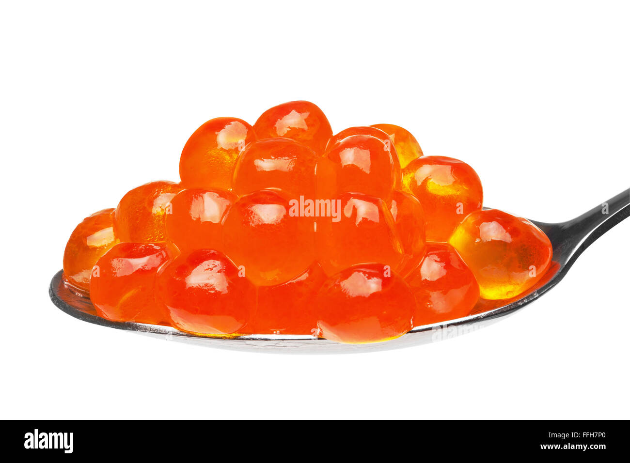 Close-up of red caviar in a teaspoon, isolated on the white background, clipping path included. Stock Photo