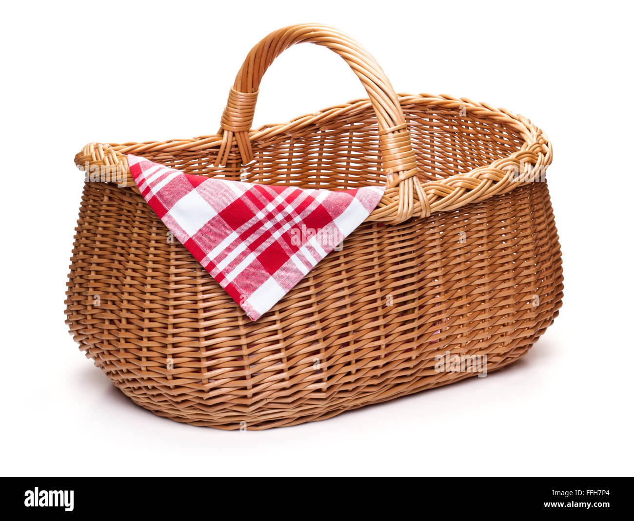 Wicker picnic basket with red checked napkin, isolated on the white background. Stock Photo