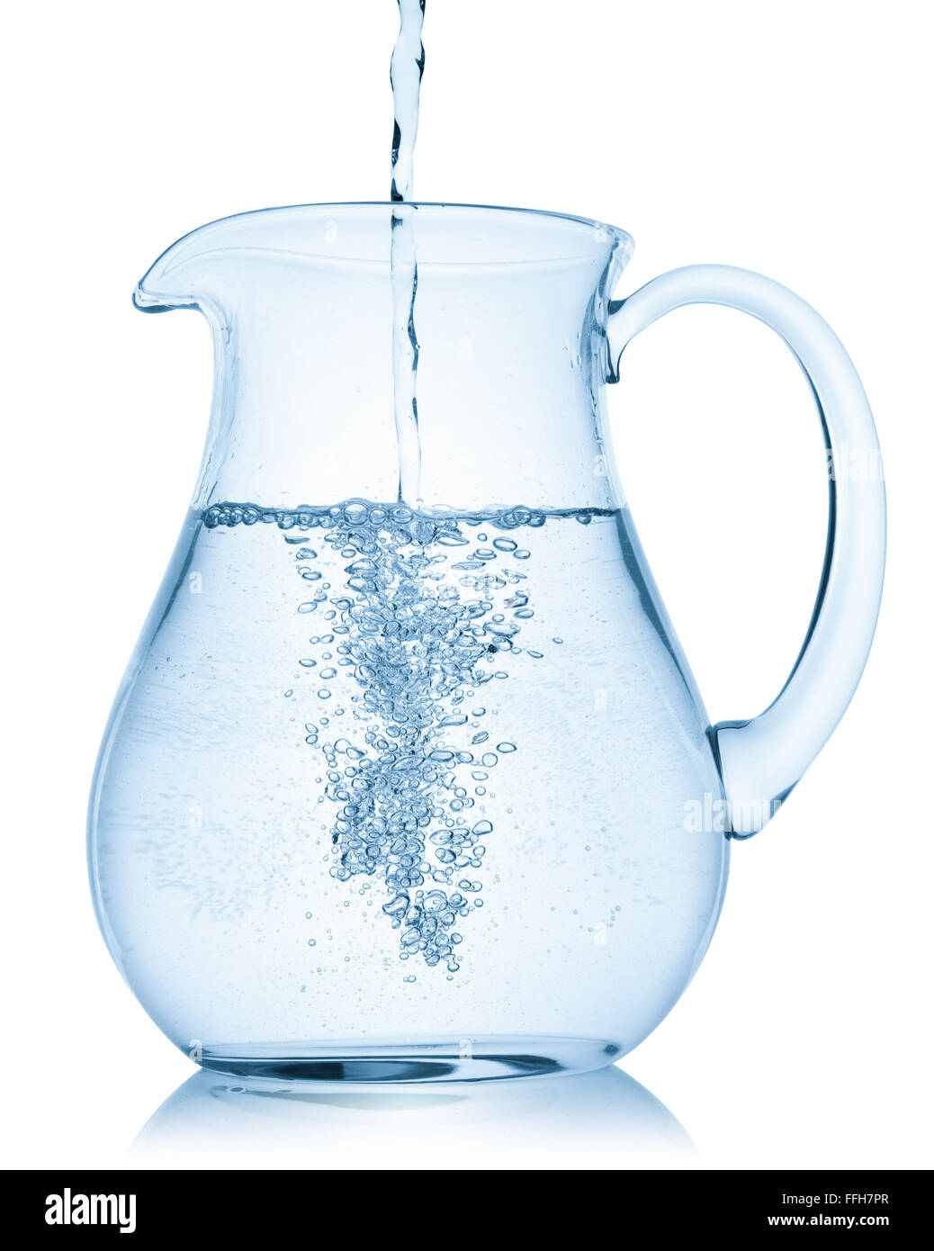 Water pouring into a pitcher, isolated on the white background, clipping path included. Stock Photo