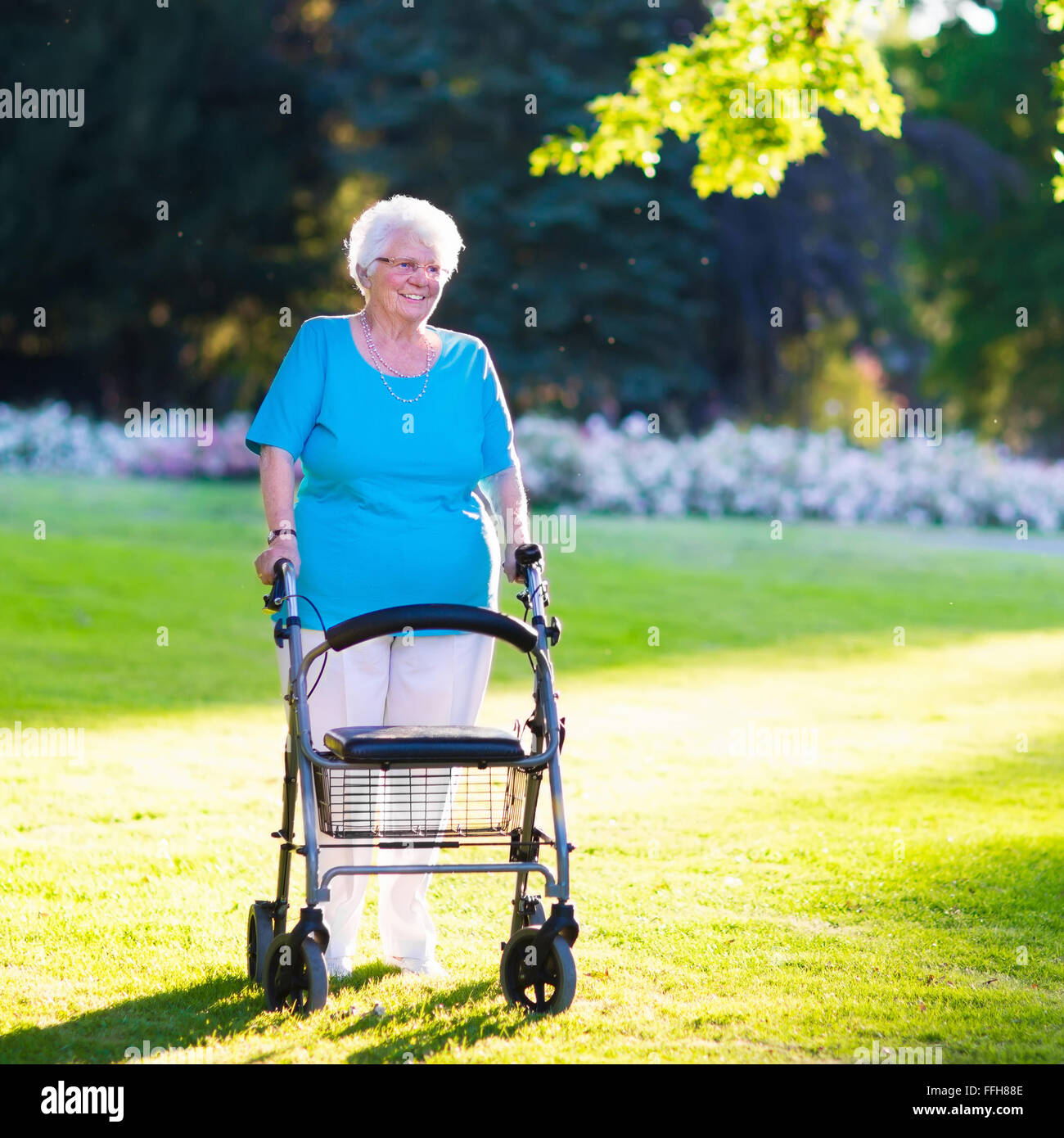 Happy senior handicapped lady with a walking disability enjoying a walk ...