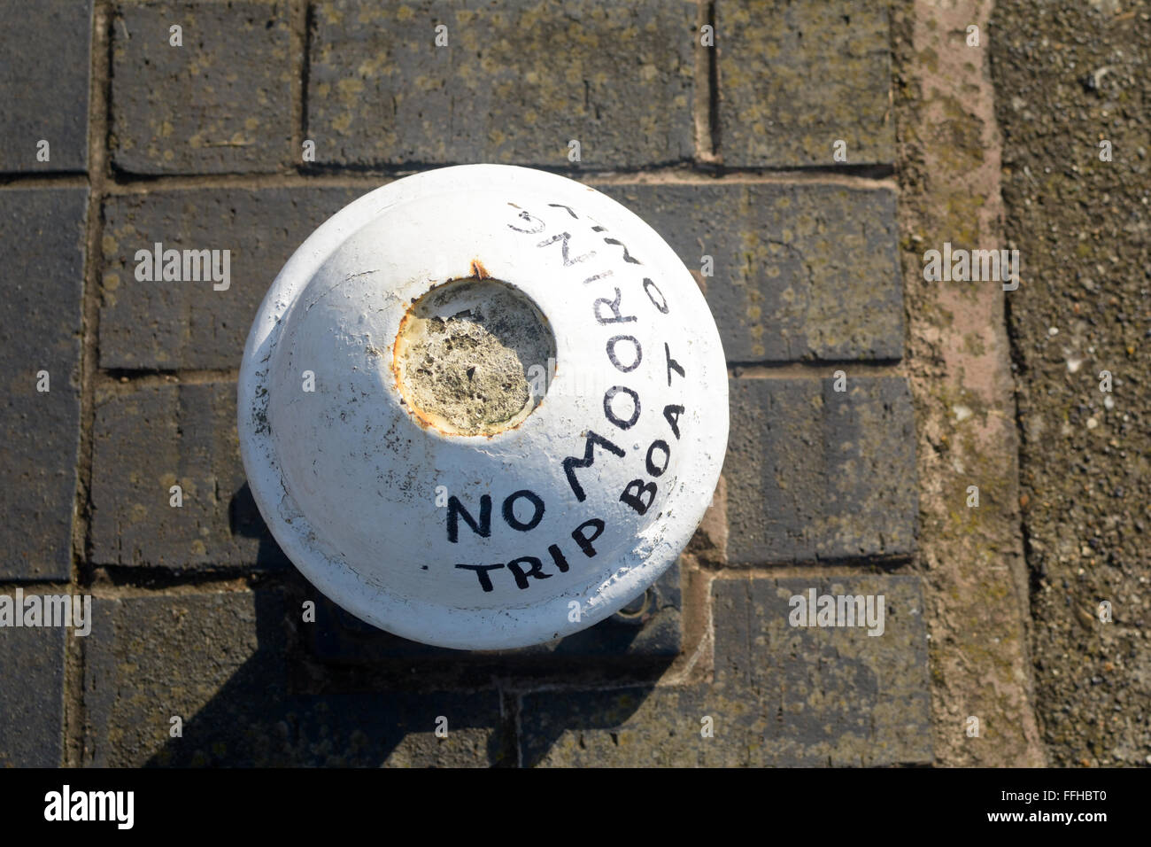 No Mooring Trip Boat Only sign painted on mooring post Stock Photo