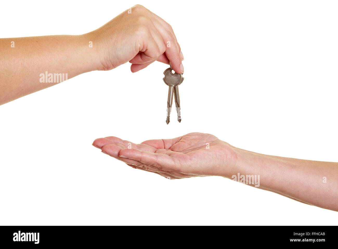 Handover of keys from one hand to another Stock Photo