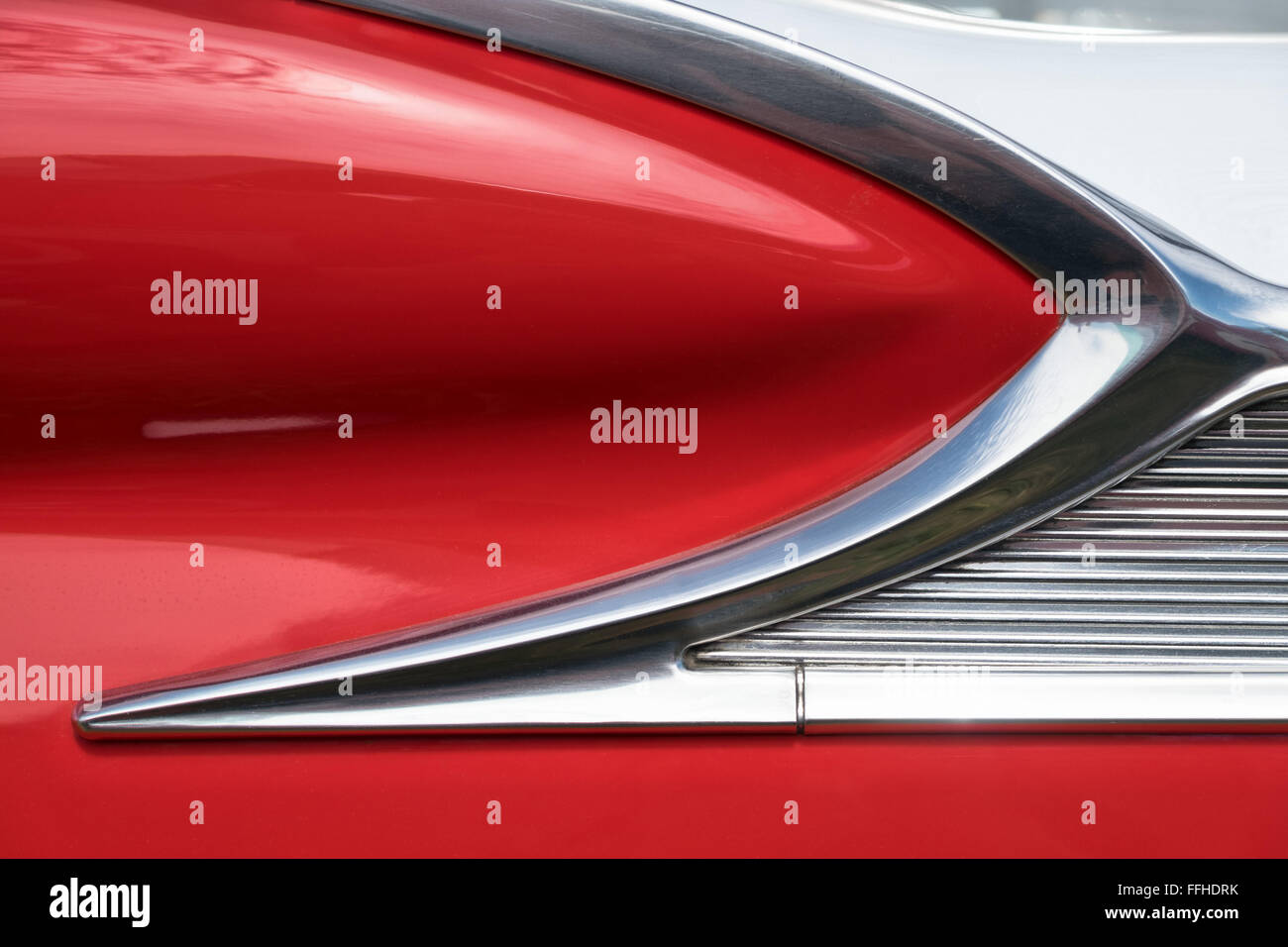 An abstract close up of the chrome detail on a red & white 1959 Ford Fairlane Skyliner with retractable hardtop Stock Photo