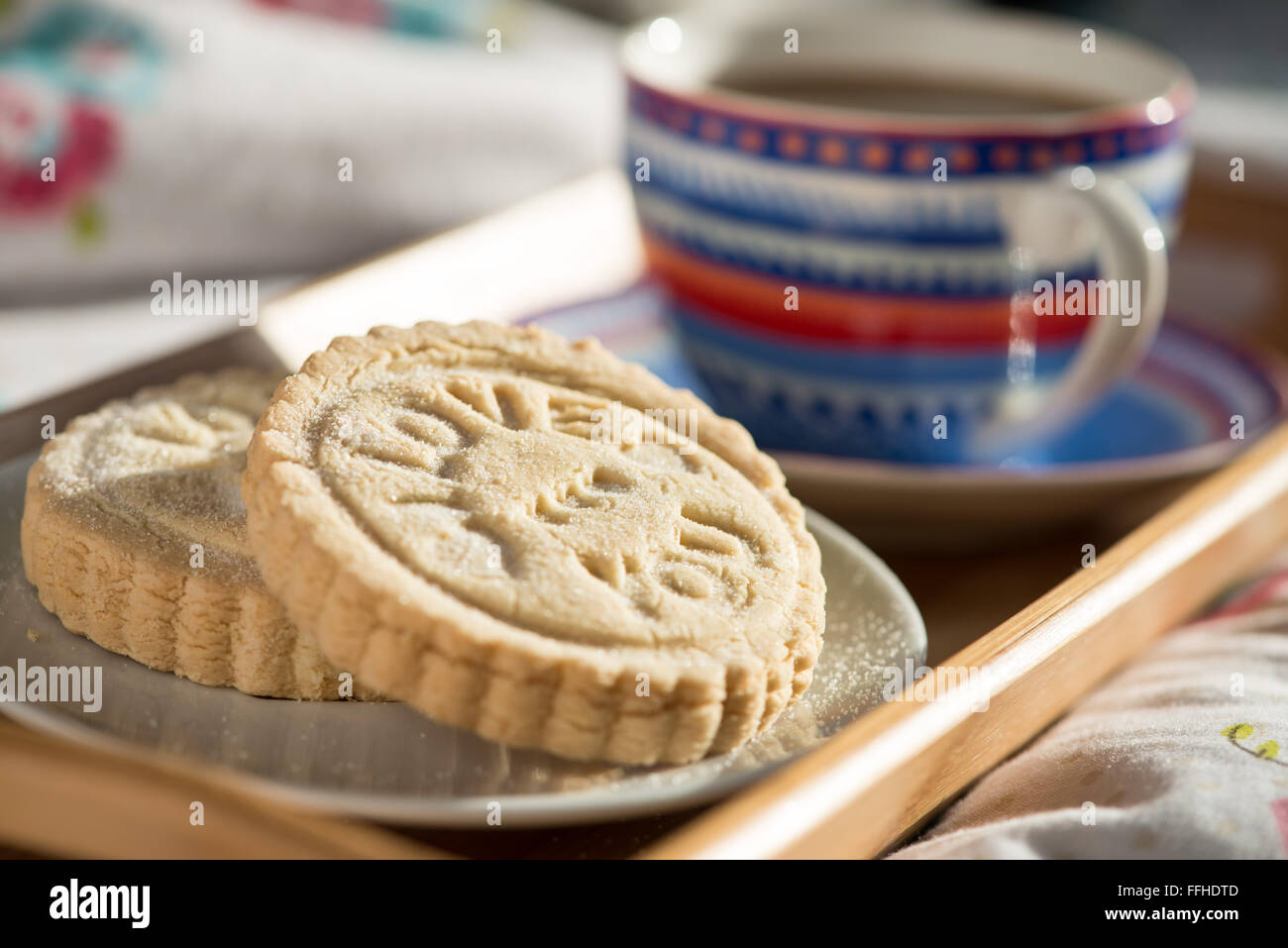 Freshly, handmade shortbread biscuits stamped with the words, I love you. Served with coffee on a tray Stock Photo