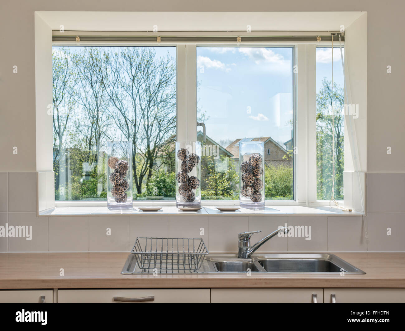 The view of a sunny day from a typical kitchen sink Stock Photo