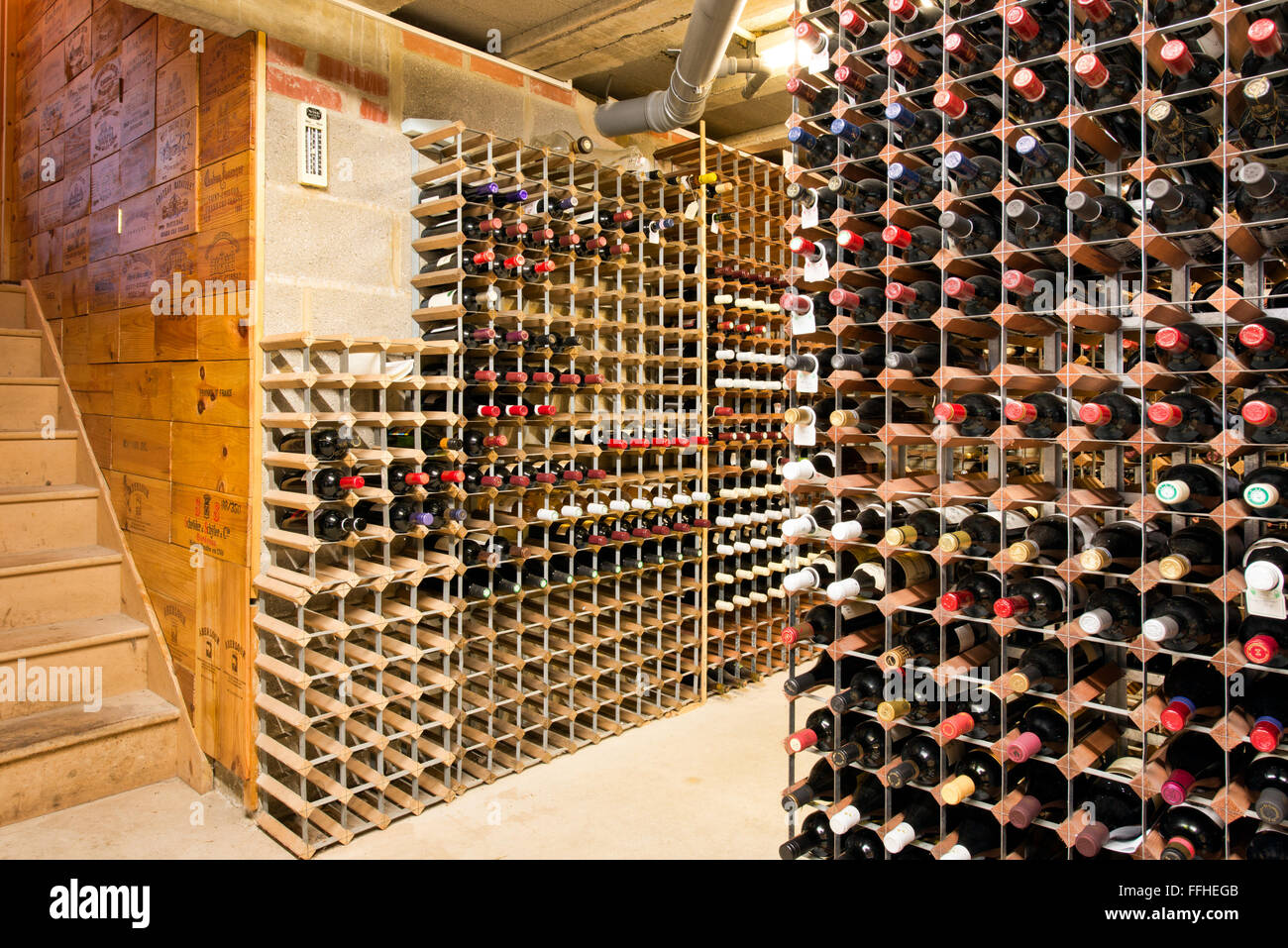 Collected bottles of wine in racks in a well stocked private. temperature controlled wine cellar Stock Photo