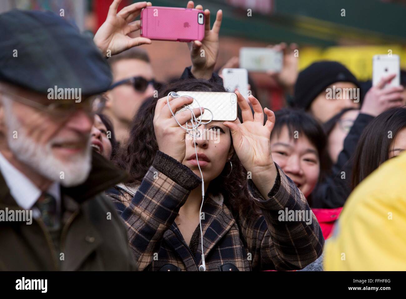 Manchester celebrates Chinese New Year today. Crowds take photos on their phones Stock Photo