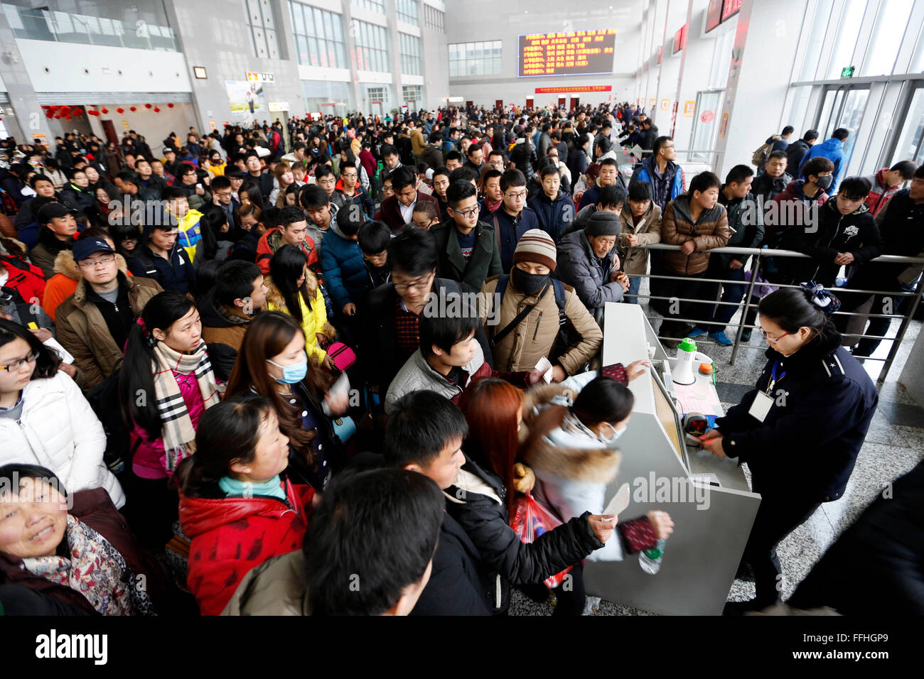 Lianyungang, China's Jiangsu Province. 13th Feb, 2016. Passengers prepare to have tickets checked at a passenger station in Lianyungang, east China's Jiangsu Province, Feb. 13, 2016. Chinese passengers made a record number of trips during the Spring Festival holiday, according to the Ministry of Transport (MOT) on Sunday. Passenger trips reached 400 million from Feb. 7 to 13, up 6.7 percent from last year, MOT data showed. Over 47 million trips were made by rail, more than 333 million on road and about 8.5 million by air. Road trips were up by 7 percent. Credit:  Si Wei/Xinhua/Alamy Live News Stock Photo