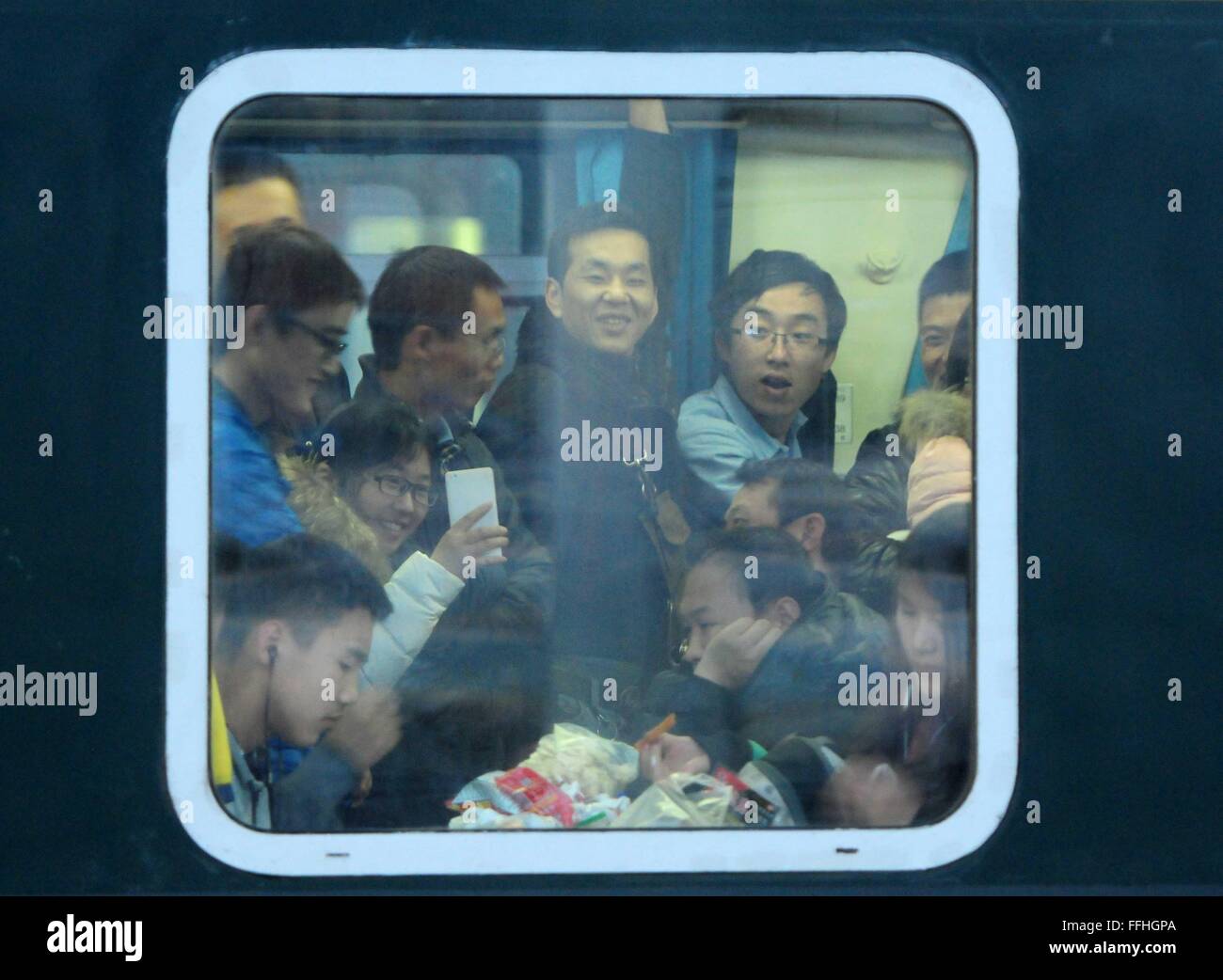Jiujiang, China's Jiangxi Province. 13th Feb, 2016. Passengers are seen in a train at the railway station in Jiujiang, east China's Jiangxi Province, Feb. 13, 2016. Chinese passengers made a record number of trips during the Spring Festival holiday, according to the Ministry of Transport (MOT) on Sunday. Passenger trips reached 400 million from Feb. 7 to 13, up 6.7 percent from last year, MOT data showed. Over 47 million trips were made by rail, more than 333 million on road and about 8.5 million by air. Road trips were up by 7 percent. Credit:  Hu Guolin/Xinhua/Alamy Live News Stock Photo