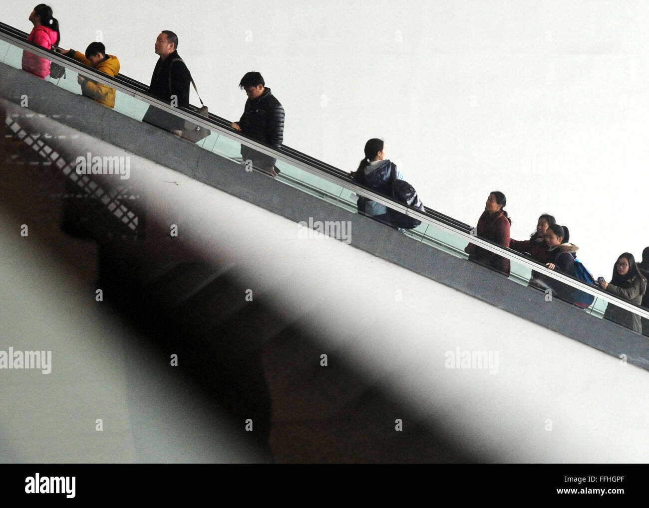 Suzhou, China's Jiangsu Province. 13th Feb, 2016. Passengers take an escalator to a waiting room at the railway station of Suzhou, east China's Jiangsu Province, Feb. 13, 2016. Chinese passengers made a record number of trips during the Spring Festival holiday, according to the Ministry of Transport (MOT) on Sunday. Passenger trips reached 400 million from Feb. 7 to 13, up 6.7 percent from last year, MOT data showed. Over 47 million trips were made by rail, more than 333 million on road and about 8.5 million by air. Road trips were up by 7 percent. Credit:  Hang Xingwei/Xinhua/Alamy Live News Stock Photo