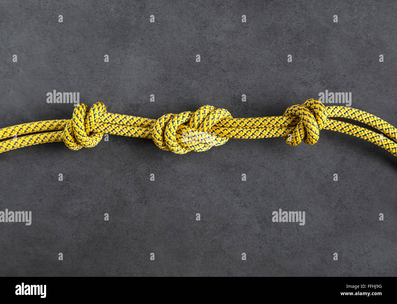 Rock climbing dynamic rope with knots. Dark background and copy space Stock Photo
