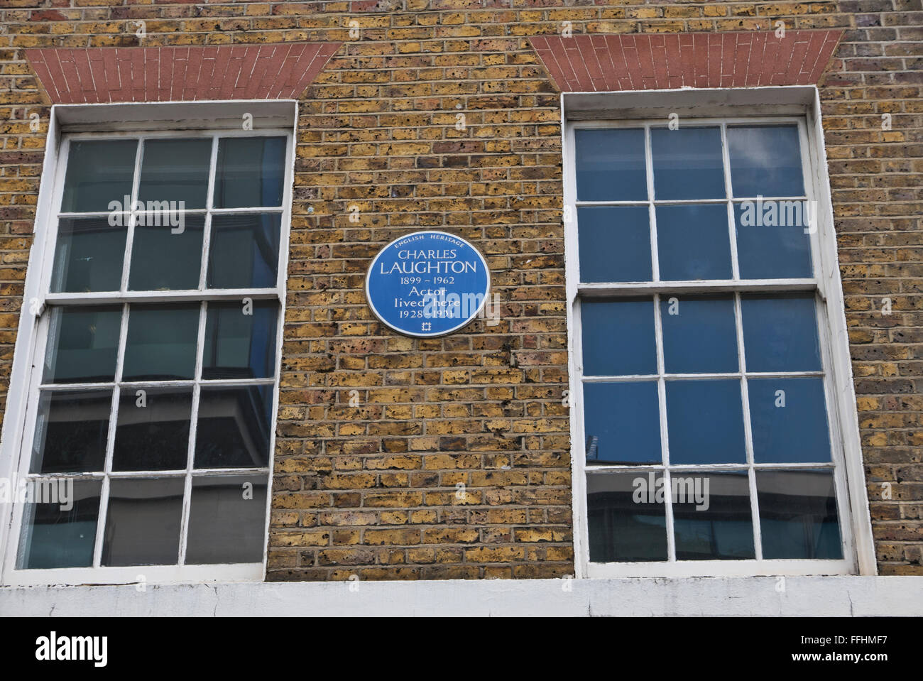 A commemorative blue plaque for Charles Laughton on display on a wall