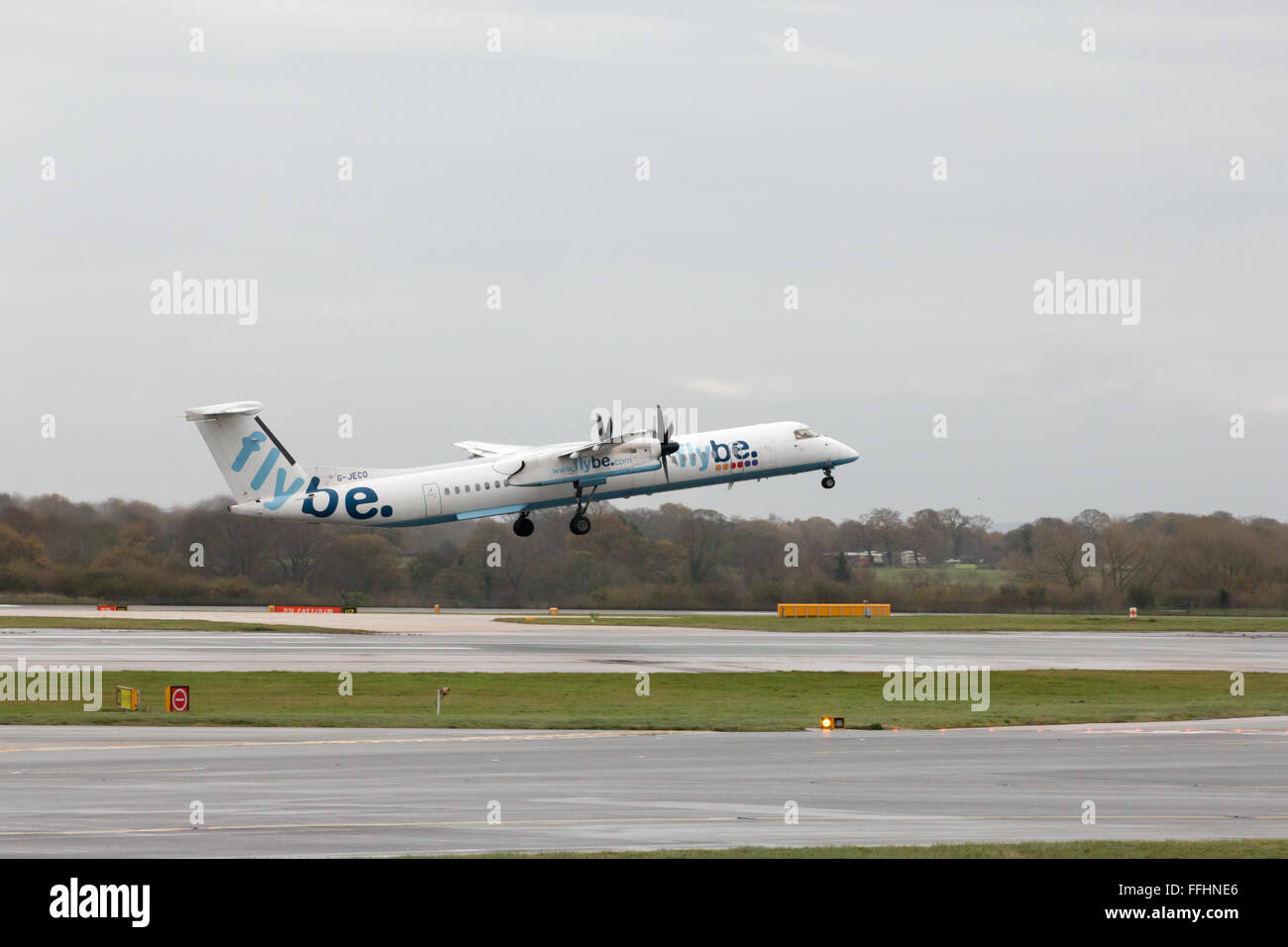 Flybe Bombardier Dash 8 Q400 regional turboprop passenger plane (G-JECO) taking off from Manchester International Airport runway Stock Photo