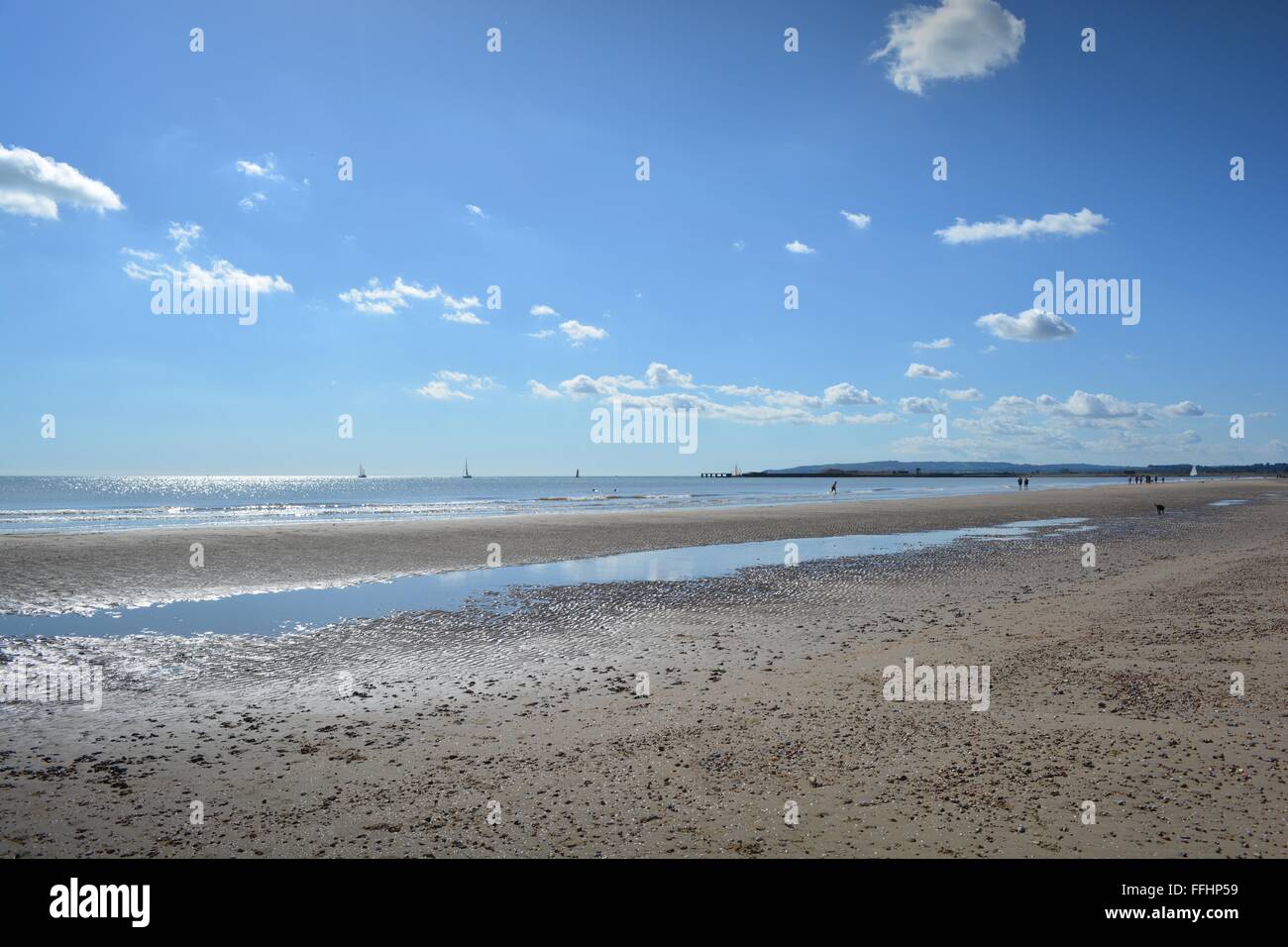 blue skies and low tide at Camber Sands in Sussex on a sunny day in September Stock Photo