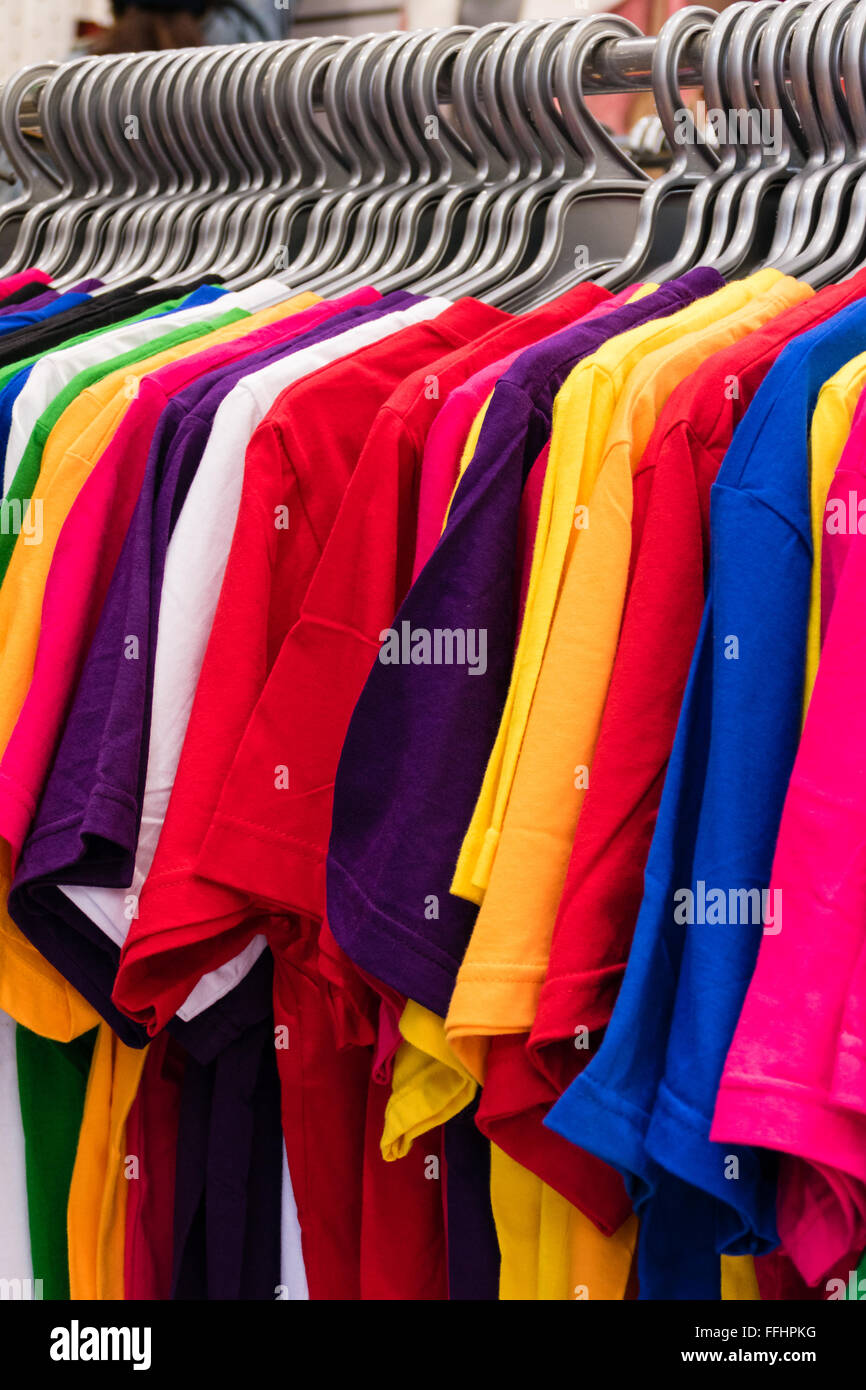 Colorful t-shirts on hangers on rack Stock Photo