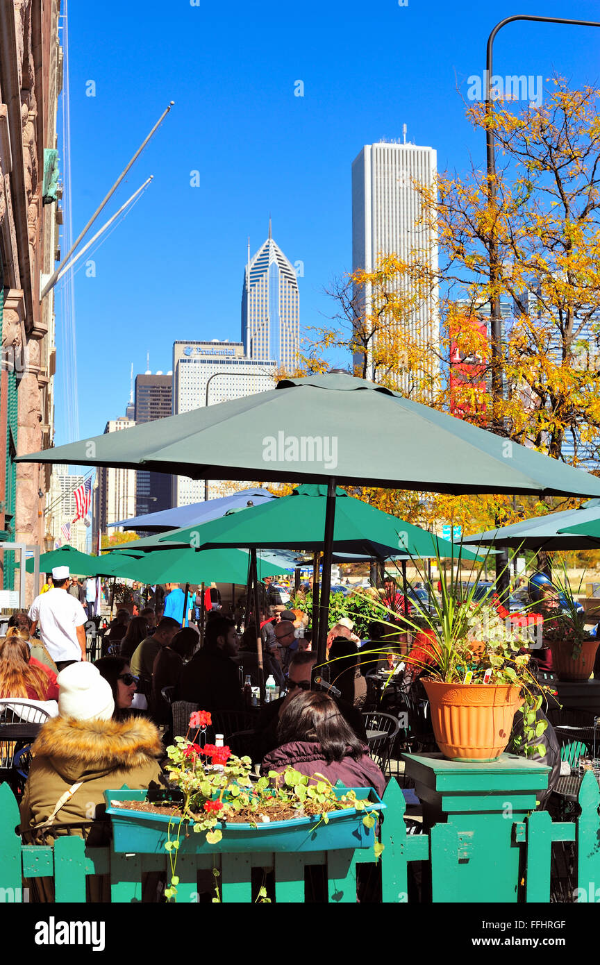 Patrons enjoy outdoor seating at a Michigan Avenue cafe in Chicago on a