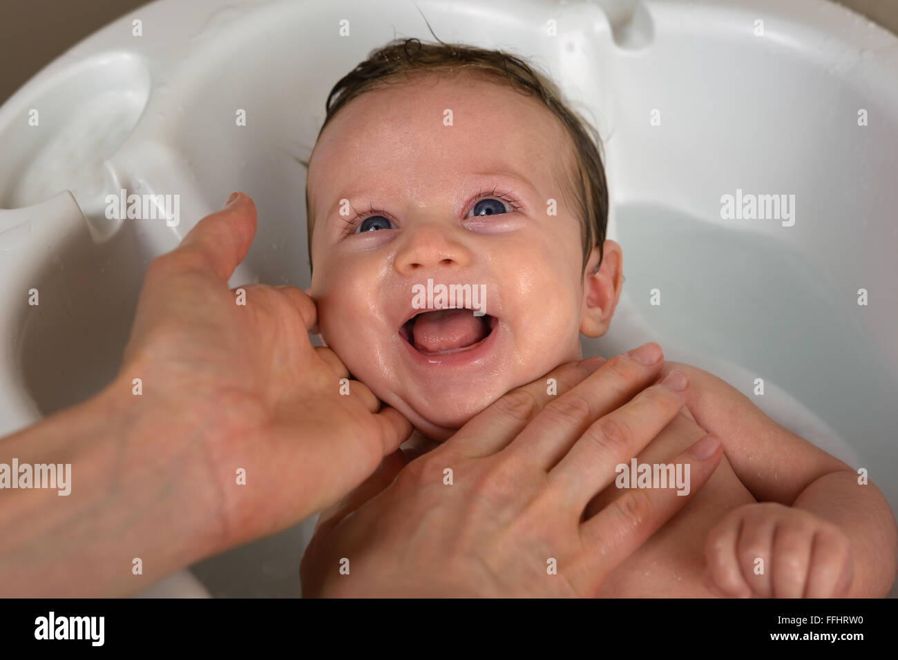 Newborn smiling while taking bath Stock Photo Alamy