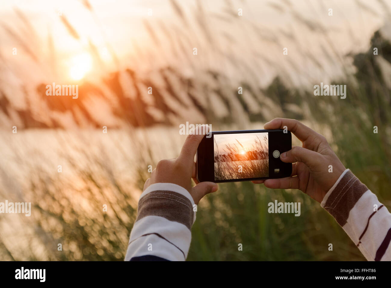 closeup hand using phone taking landscape photo Stock Photo