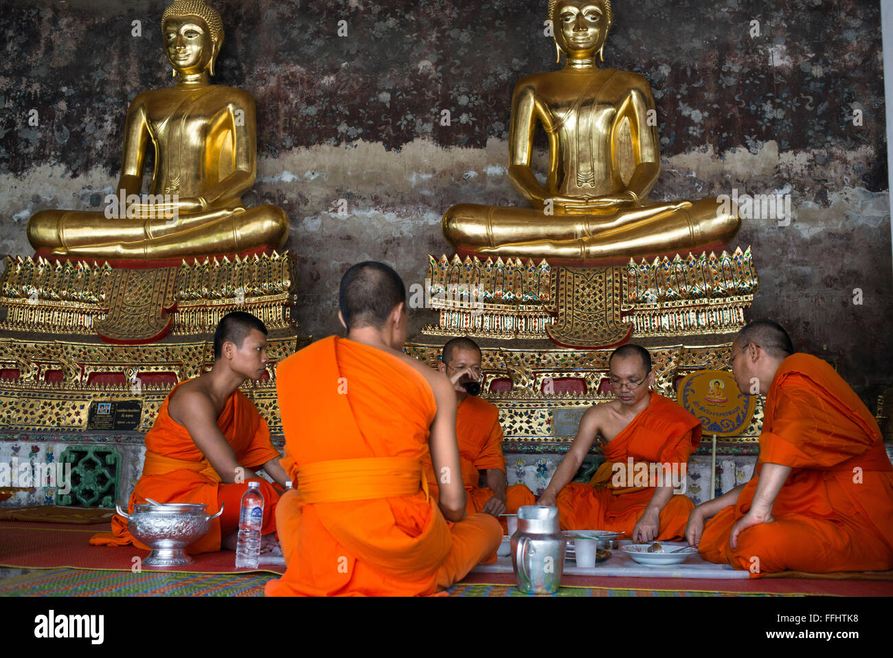 Monks praying in Wat Suthat Thepwararam Temple. Bangkok. Monks at Wat Suthat Thepwararam Ratchaworamahaviharn, Bangkok, Thailand Stock Photo