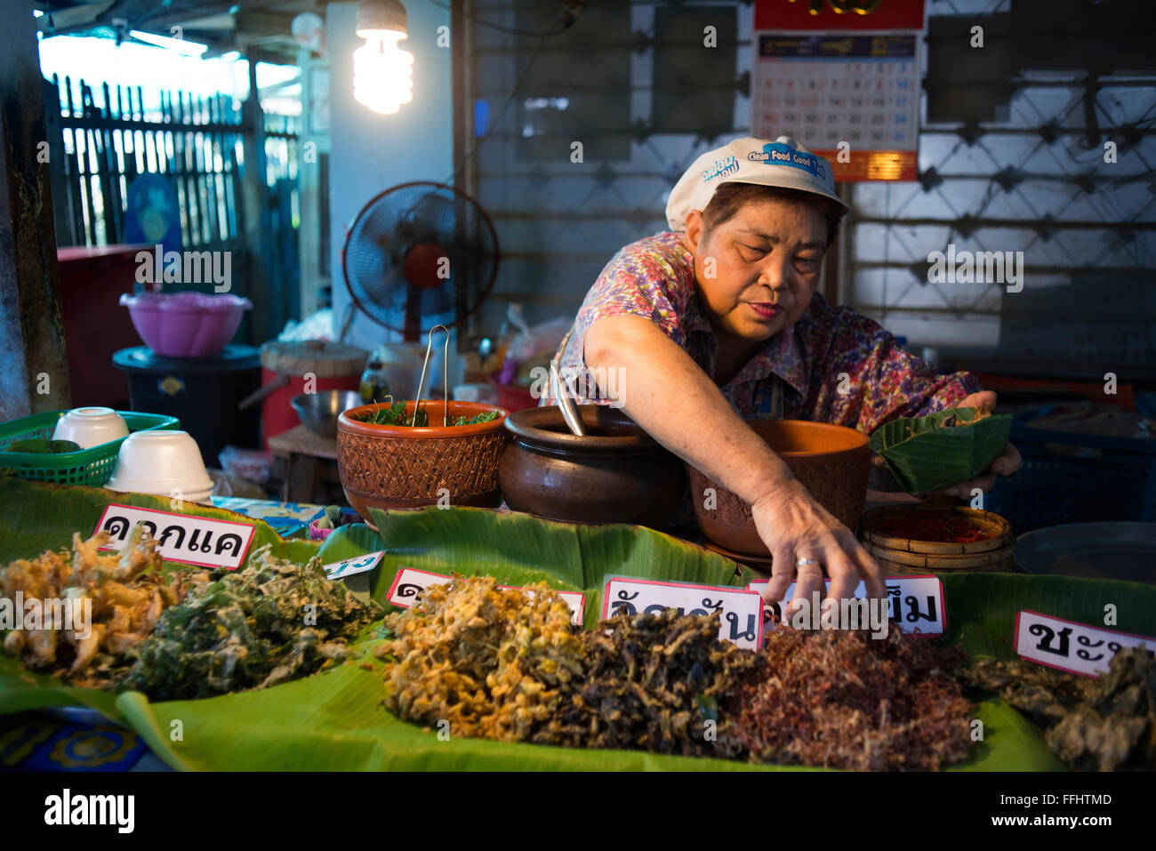 Woman seller. Food stall. Fish, vegetables, fast food. Ko Kret (also Koh Kred) is an island in the Chao Phraya River, 20 km nort Stock Photo