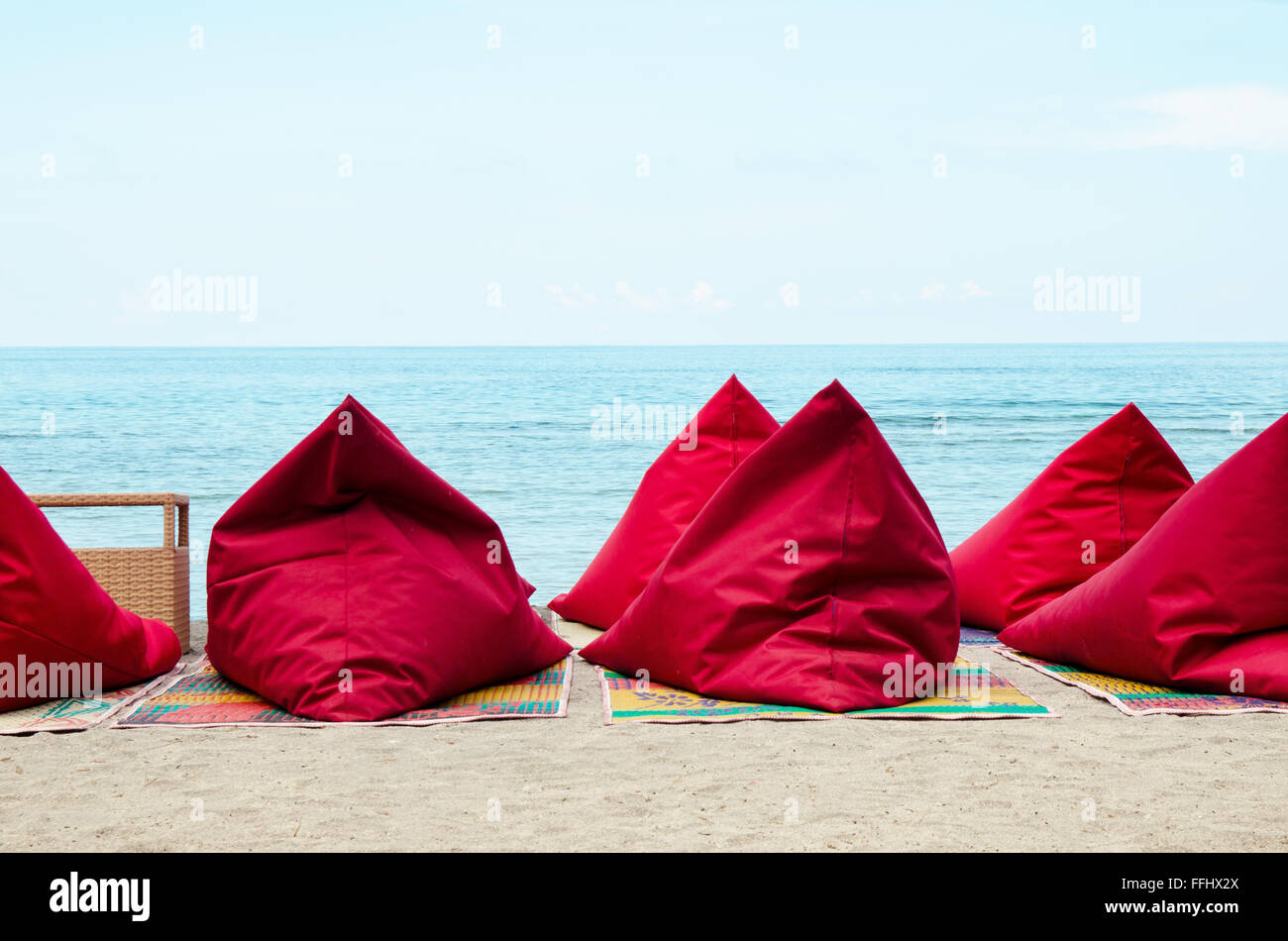 Red bean bags on the sand beach in Bali, Indonesia. Stock image Stock