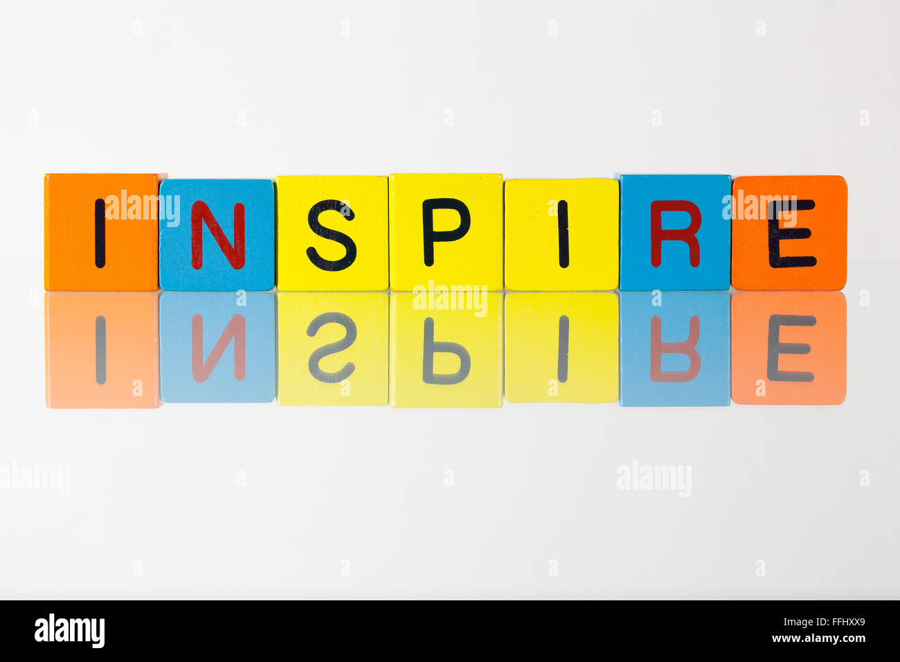 Inspire - an inscription from children's wooden blocks Stock Photo