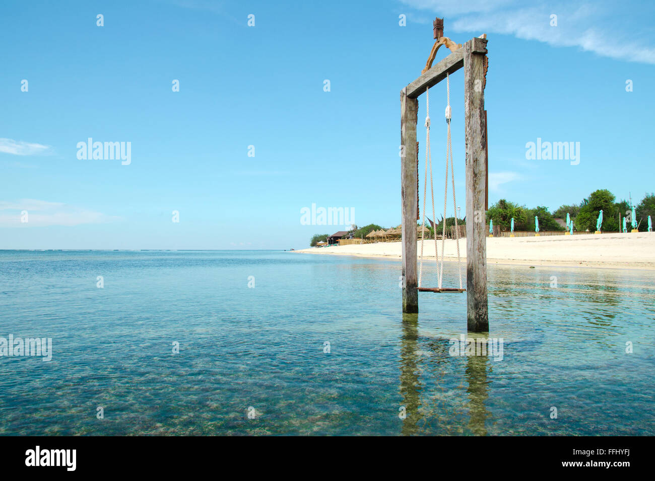Bali, Indonesia. Exotic beach. Swing located in the ocean near the island of Gili. Stock Image Stock Photo