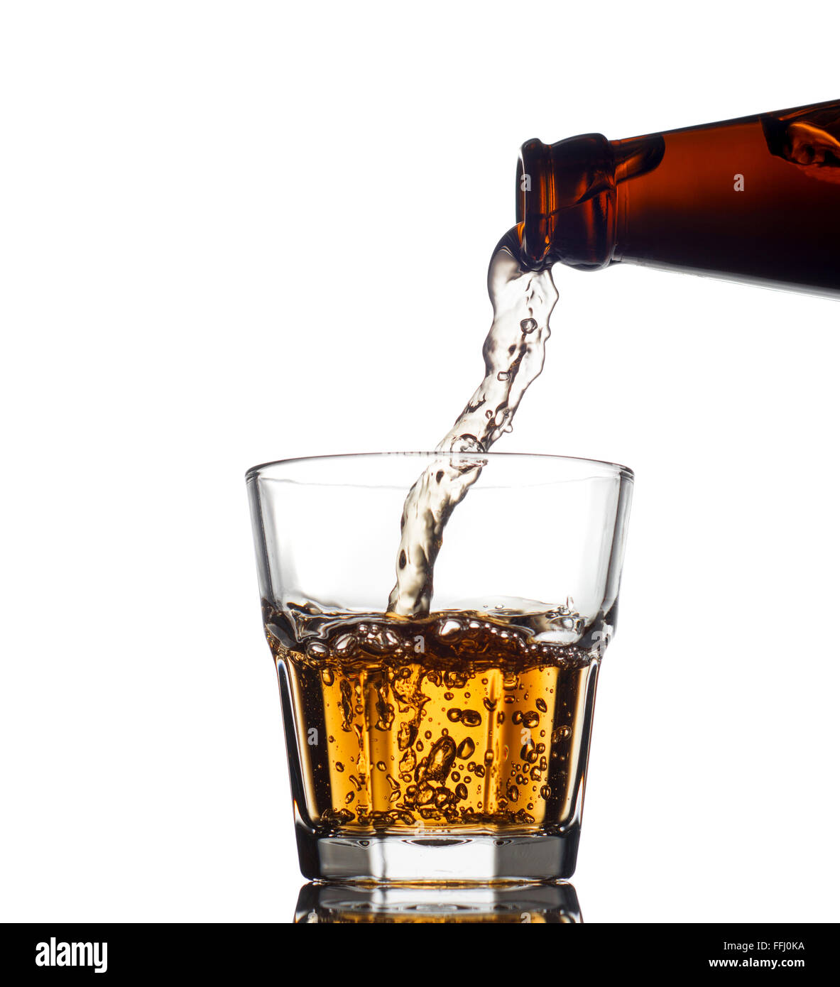 Pouring whiskey in a clear glass, on white background Stock Photo Alamy