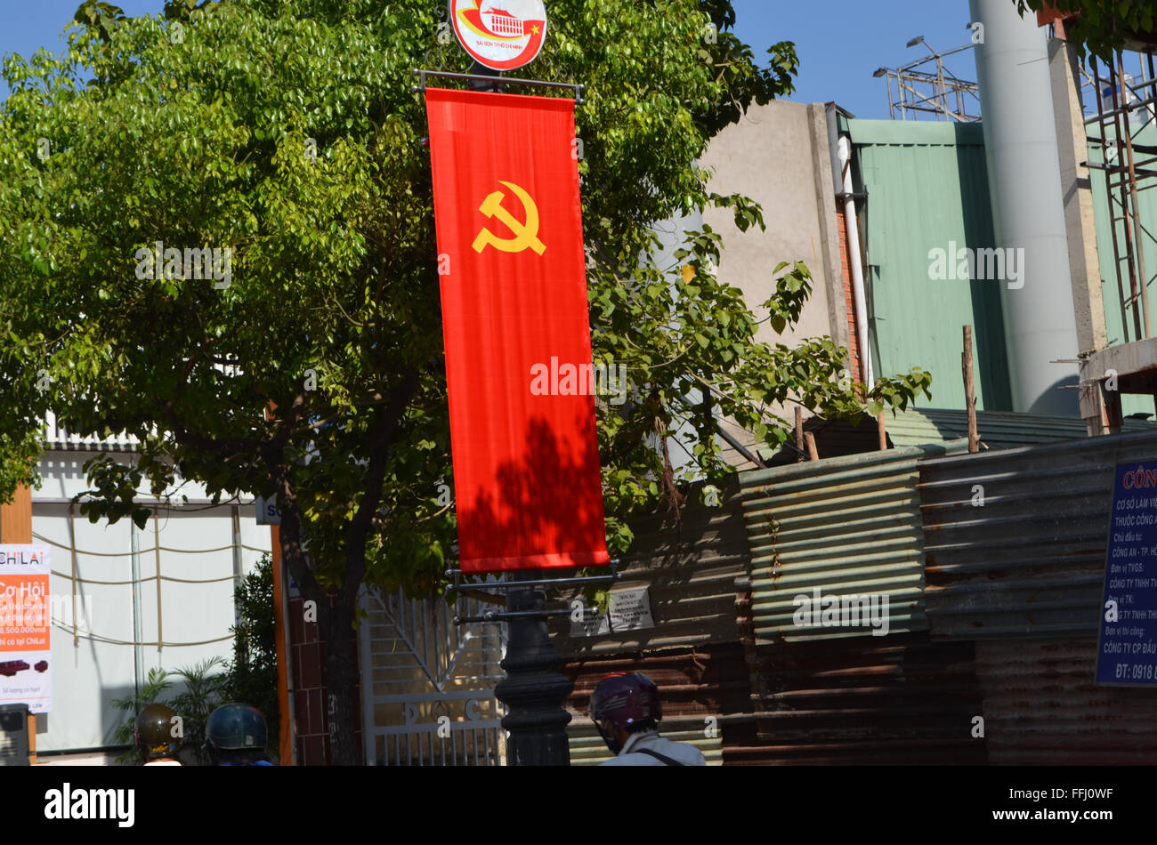 Saigon, Viet Nam. They love their flag in Saigon,they display it on every lamp post, and tree, and other wayside pillar that can Stock Photo