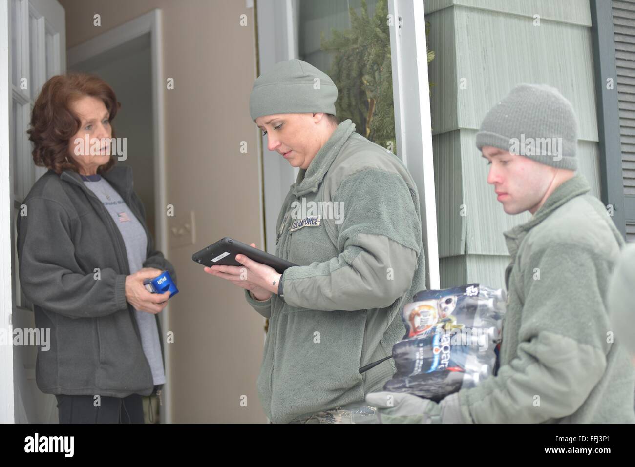U.S Air Force airmen with the Michigan National Air Guard distribute bottled water to residents effected by lead contamination in the city drinking water January 21, 2016 in Flint, Michigan. As many as 12,000 children have been exposed to dangerous drinking water after the state government switched water supplies without complying with federal regulations on safety. Stock Photo