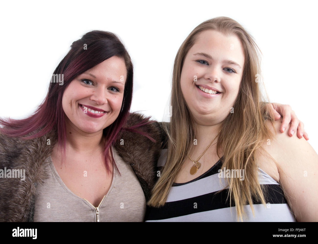 two friends smiling studio shot over white background Stock Photo