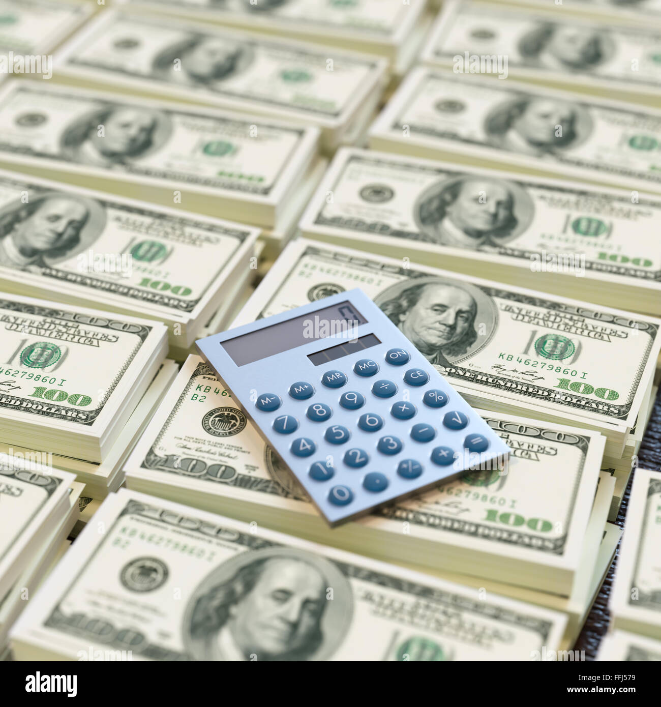 Calculator on 100 dollar banknotes Stock Photo - Alamy