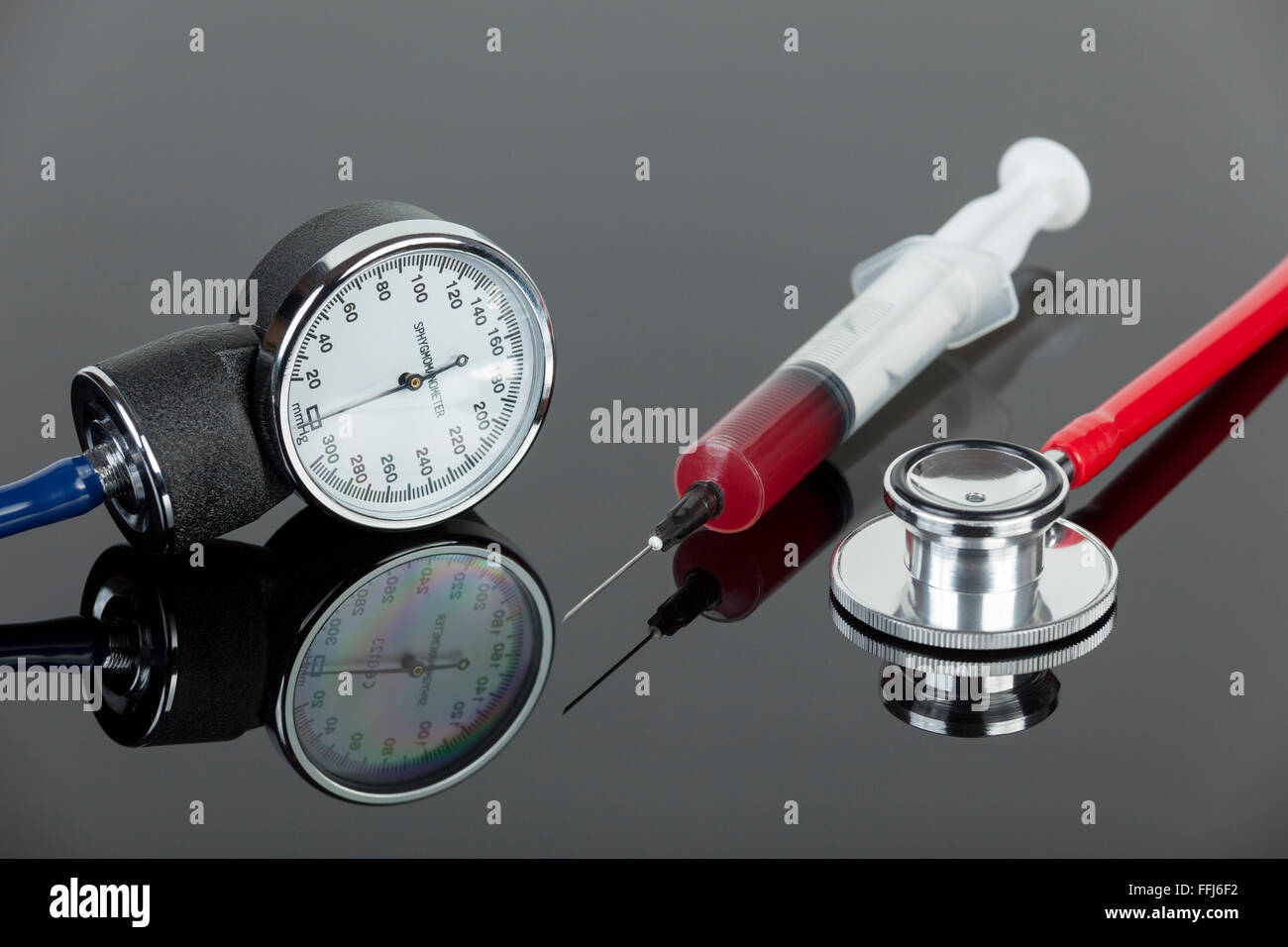 Sphygmomanometer with stethoscope and a blood filled hypodermic needle