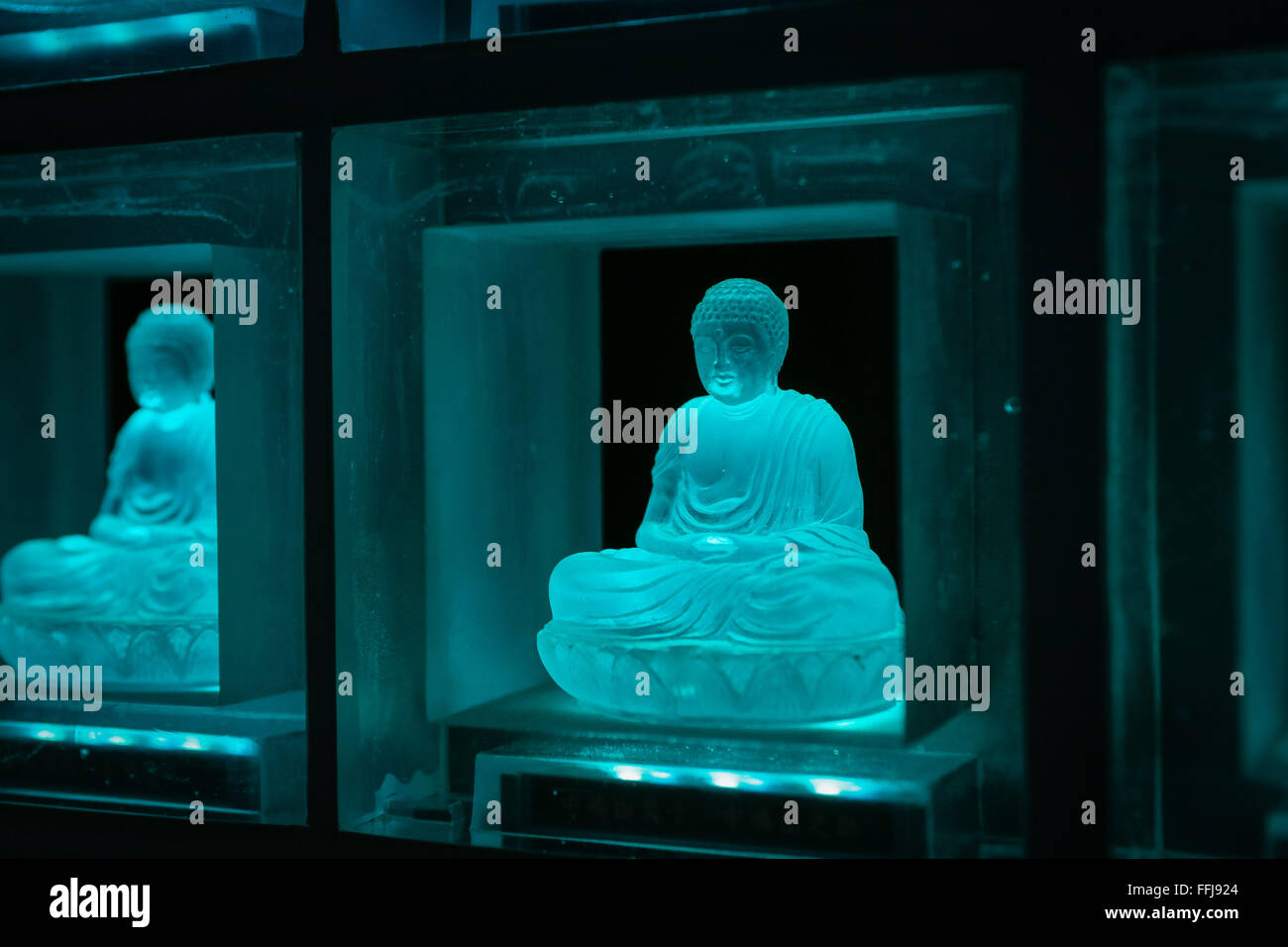 The Ruriden memorial hall at the Koukoko-ji temple on February 11, 2016 in Tokyo, Japan. In a country with an ageing population and a premium on space it is a modern collective tomb. Inside the hexagonal mausoleum there are over 2000 glass Buddhas lit by LED lights. Behind the Buddhas are compartments to store the ashes of the deceased. The light display changes color and pattern according to the season and time, and using a card reader system visitors can touch their card and display will change to indicate the Buddha representing their deceased. © Martin Hladik/AFLO/Alamy Live News Stock Photo