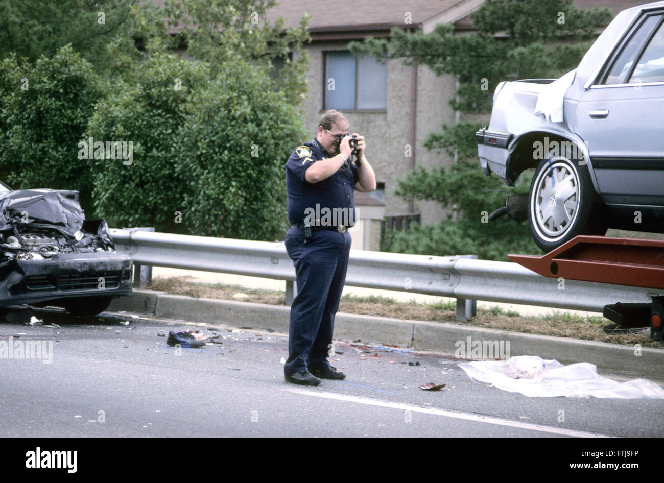 policeman photographs evidence at a crime scene in Greenbelt, Maryland