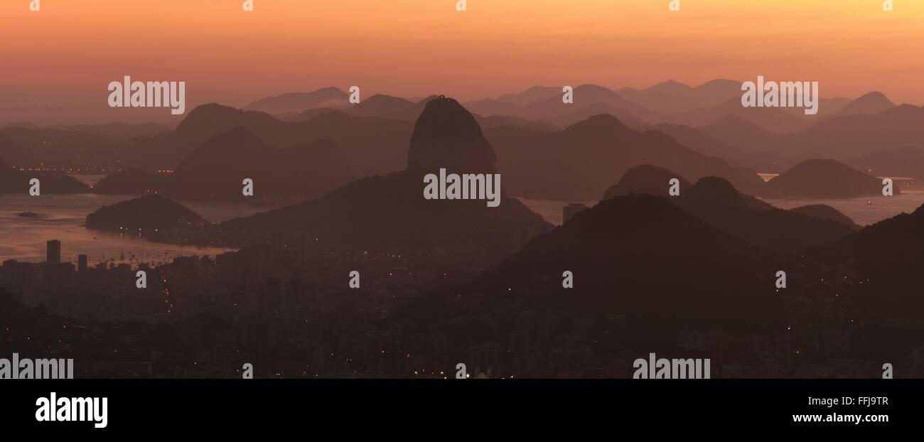 Rio de Janeiro, Brazil, 14th February. Rio de Janeiro at sunrise, seen from Vista Chinesa (Chinese Belvedere) in Tijuca Forest National Park. Sugarloaf is seen at centre.Stitched panorama. Credit: Maria Adelaide Silva/Alamy Live News Stock Photo