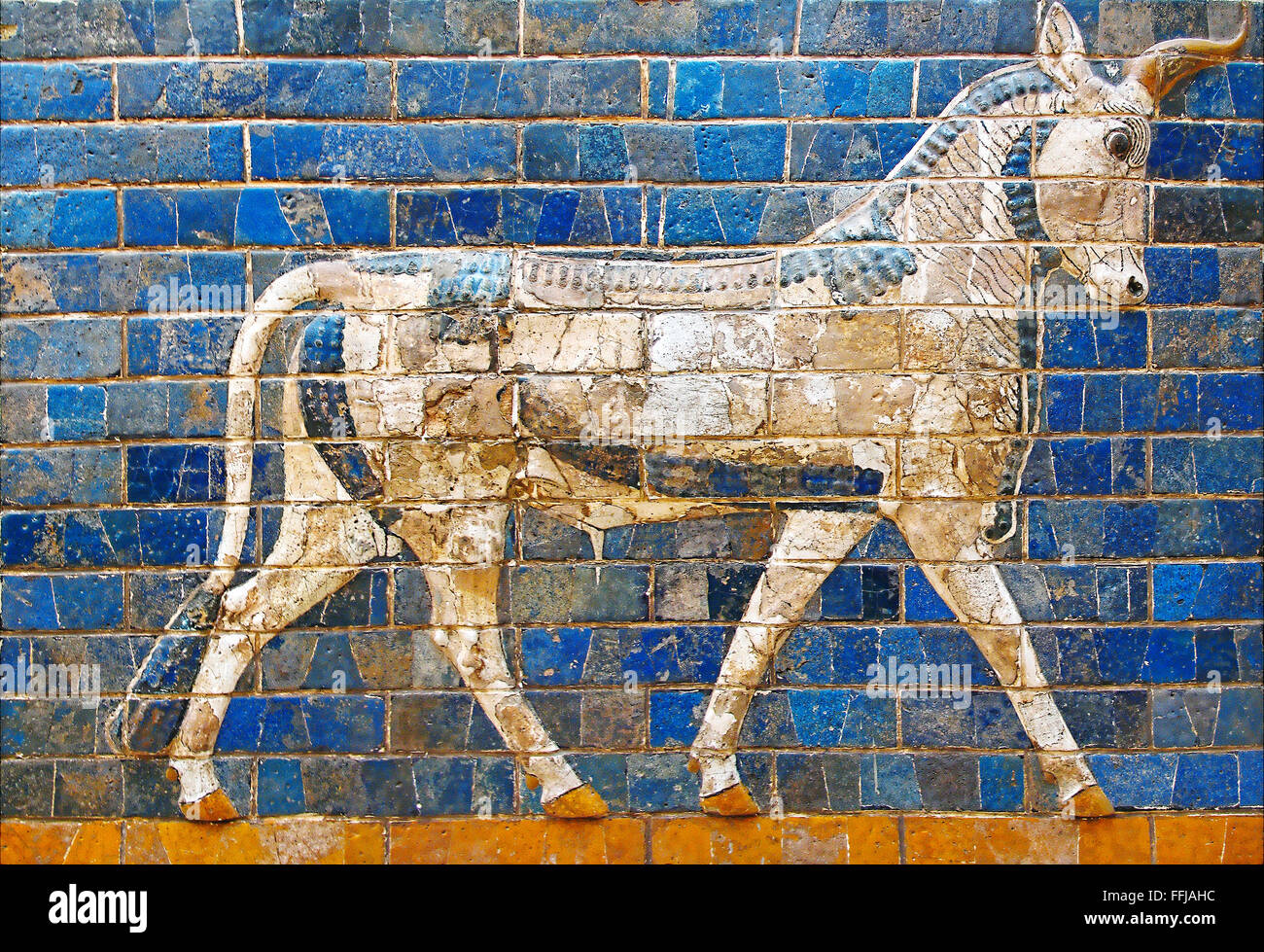 Ancient mosaic on the Ishtar Gate wall with mythical bull, Istanbul museum. Babylonian mosaic, fragment of the Ishtar Gate Stock Photo