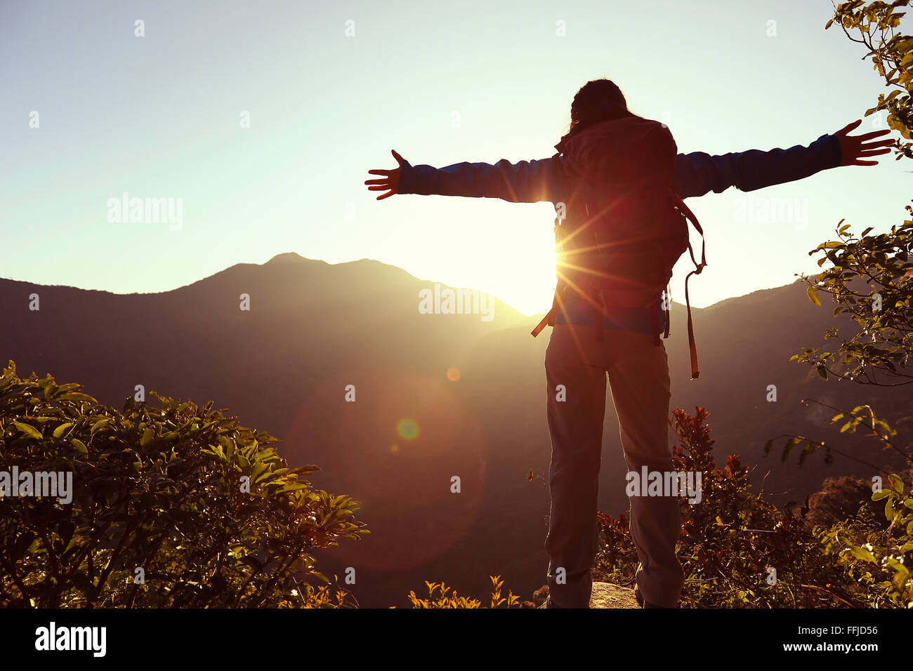 successful woman hiker open arms on sunrise mountain peak Stock Photo ...