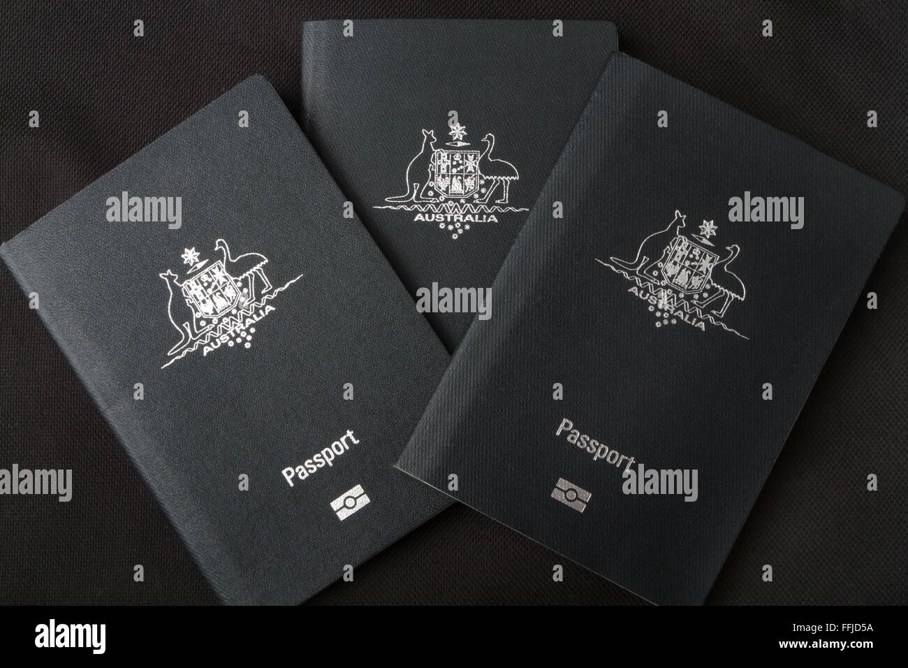 Three Australian passports on a black background Stock Photo Alamy