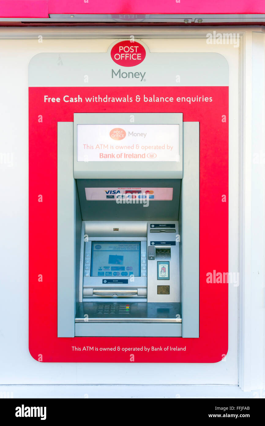 A red UK Post Office ATM providing services by the Bank of Ireland  hole in the wall money machine Stock Photo