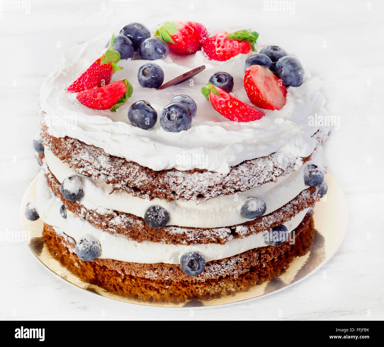 Cake with cream, blueberries  and strawberries. Stock Photo